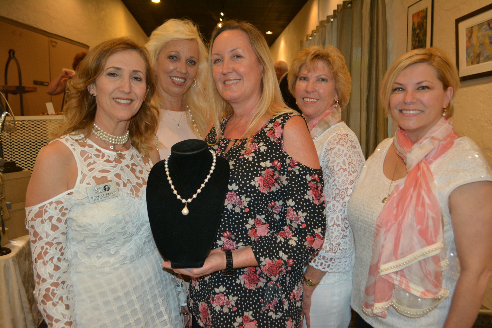 Sisterhood for Good's Michelle Bianchi, Wanda Martinetto, Kathy Fraley, Kathy Collums and Angela Massaro-Fain pose with the necklace being auctioned off to raise money for charity.