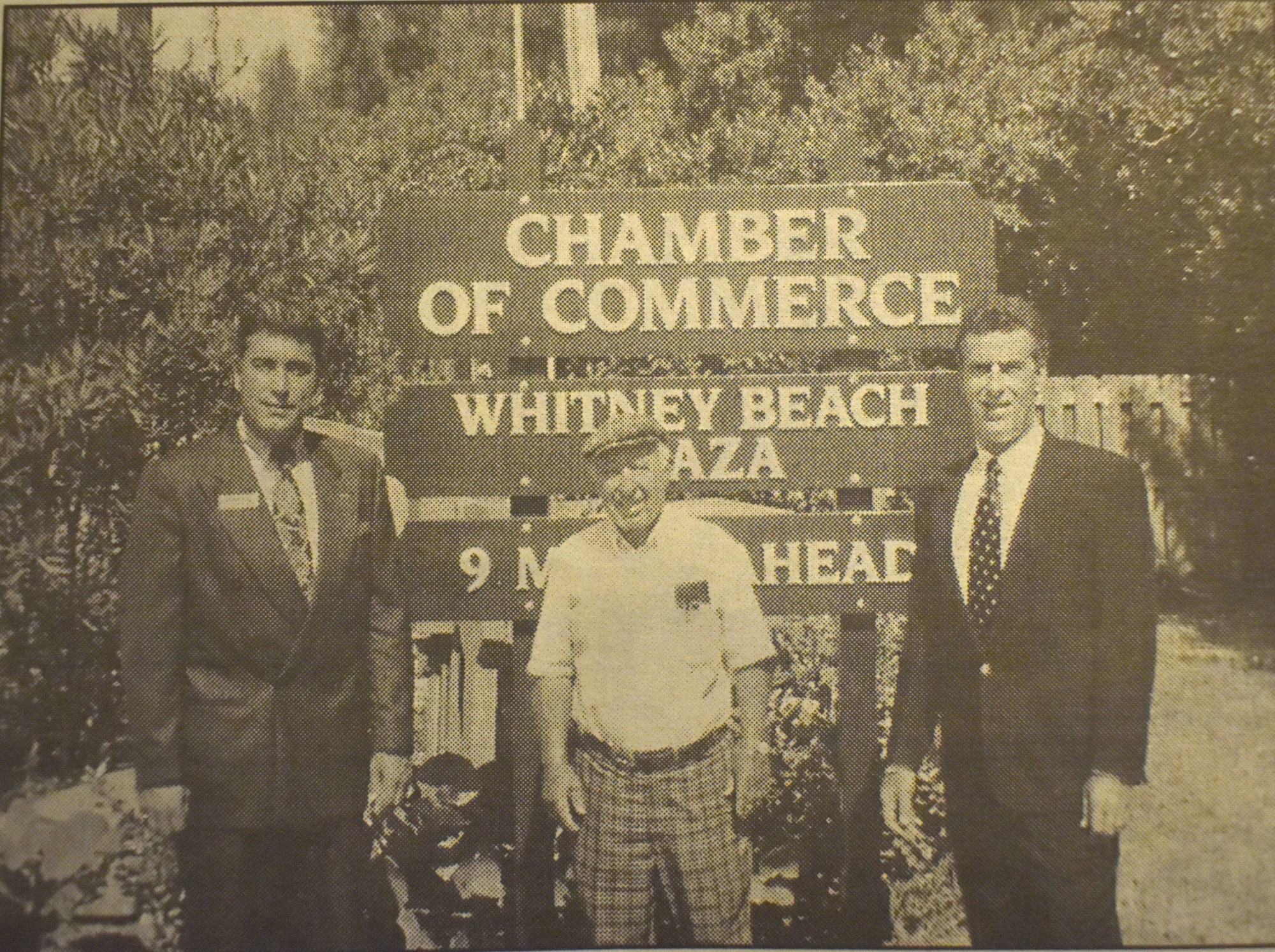Andrew Vac, Win Cook and Sam Esber stand in front of the sign that replaced the welcoming boat. File photo.