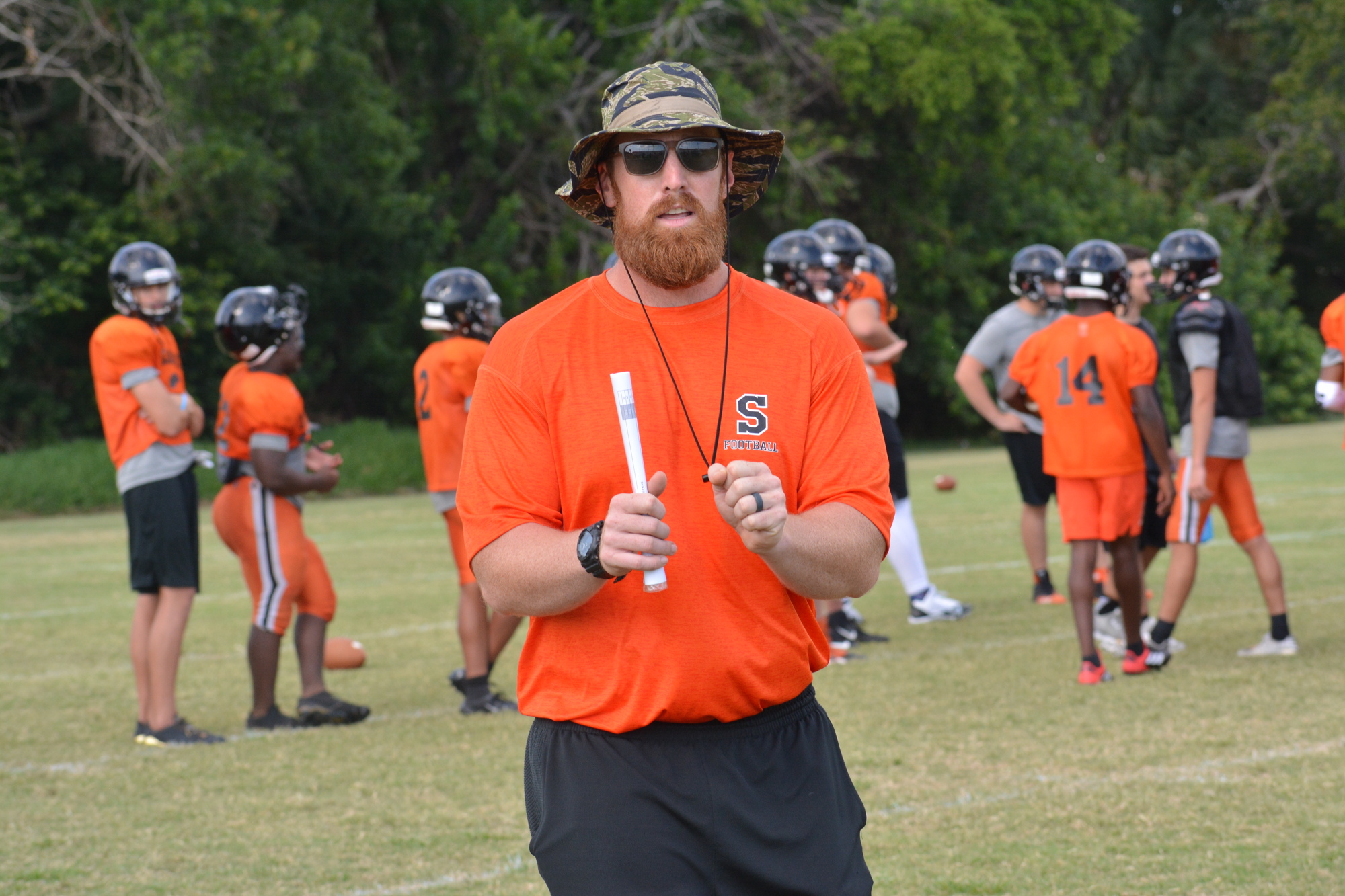 Sarasota High head coach Spencer Hodges gives his team pointers during spring practice.
