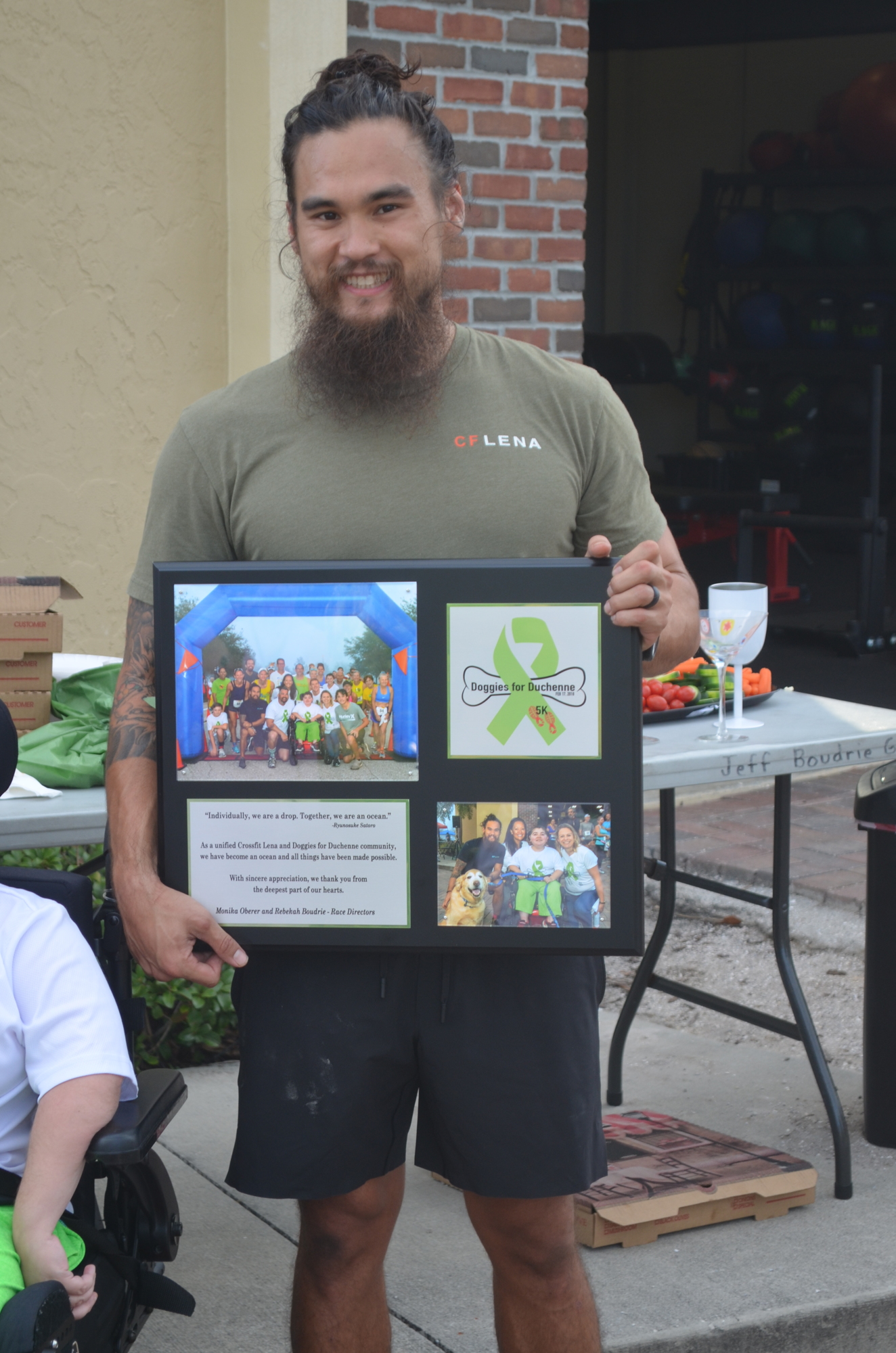 Josh Davis, the owner of CrossFit Lena,  received a plaque for hosting the race.