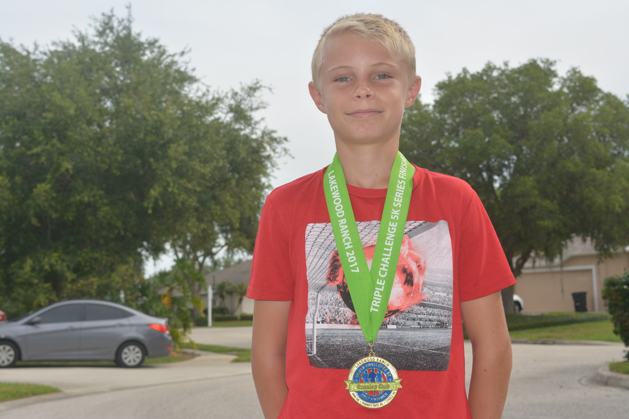 Jonathan Leatt wears his favorite medal, from the 2017 Triple Challenge (finishing the Boo Run, Turkey Trot and Jingle Run 5Ks).