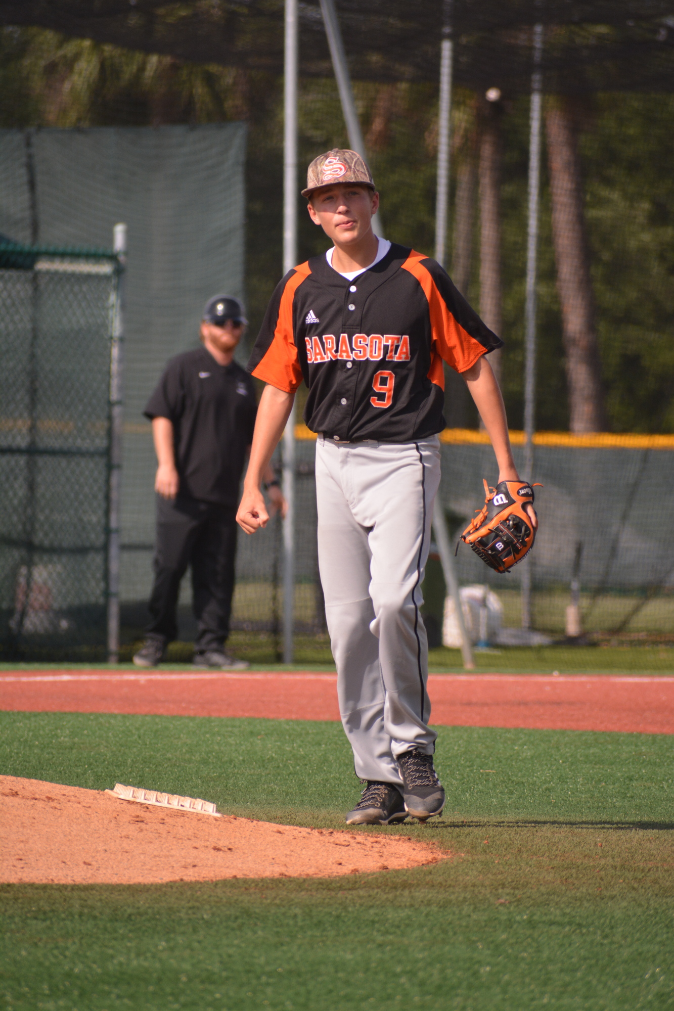 Conner Whittaker walks to the mound after making a diving defensive play.