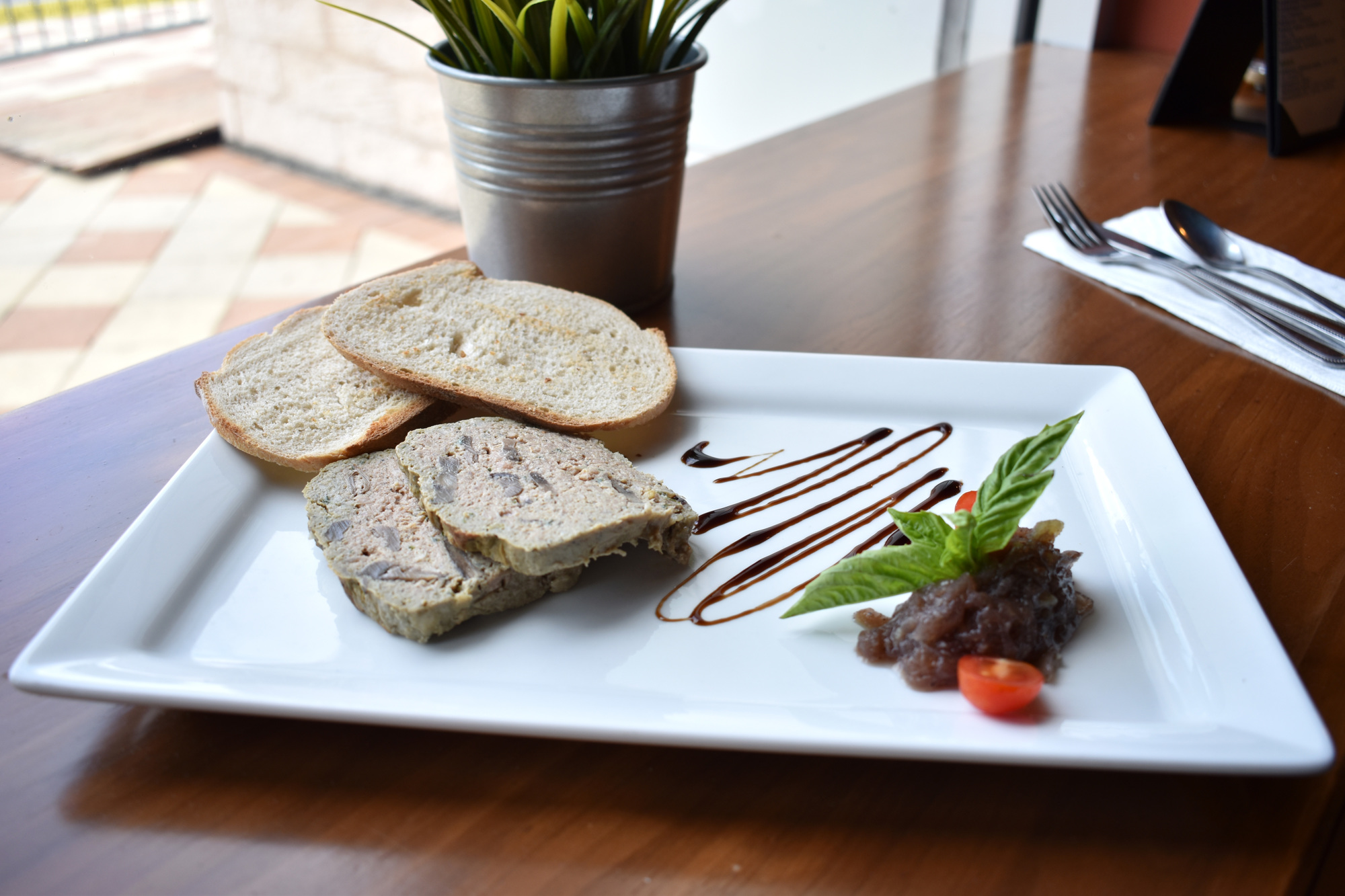 The homemade pate de campagne on C'est La Vie's Savor Sarasota Restaurant Week menu is served with onion jam and blackcurrant cream, pickles and toast. Photo by Niki Kottmann 