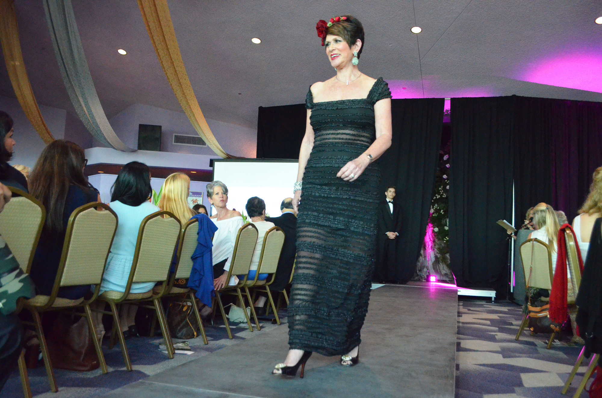 Wendy Feinstein struts the runway in one of her own dresses that she donated to Selah Vie Boutique. Photo by Niki Kottmann