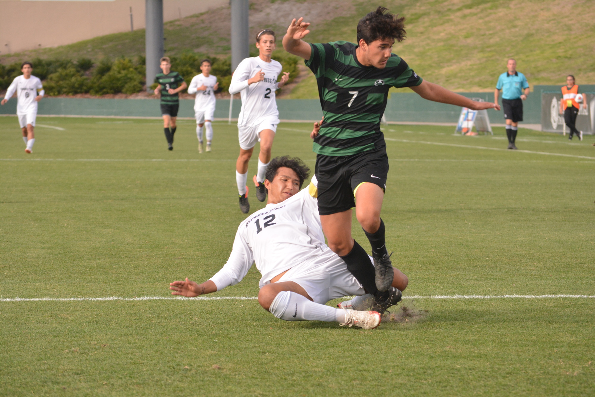 Ricky Yanez hops over a defender after an attempted tackle.
