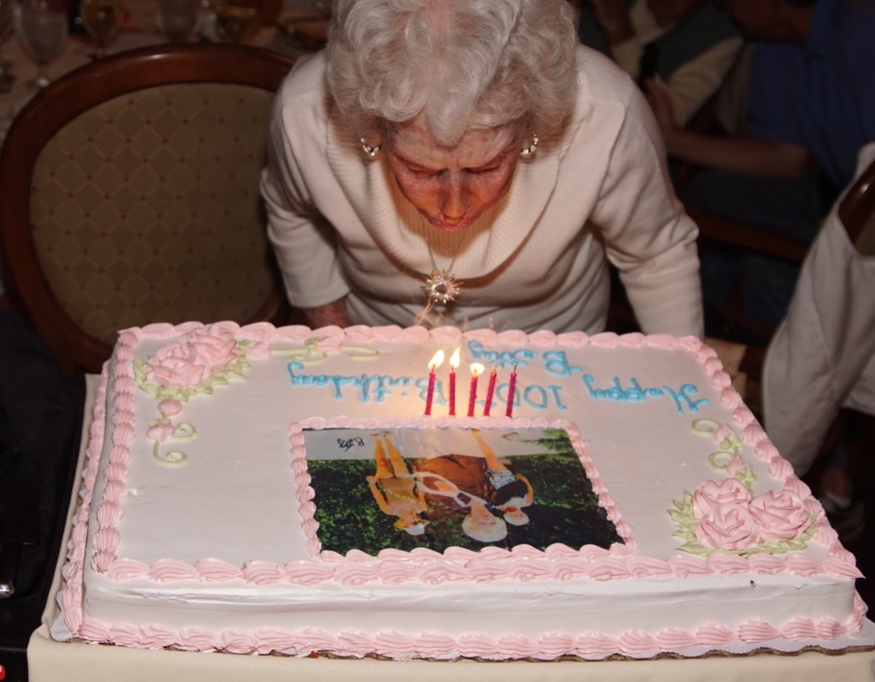 Betty Andreone blows out the candles on a cake that commemorates her appearance in the movie 