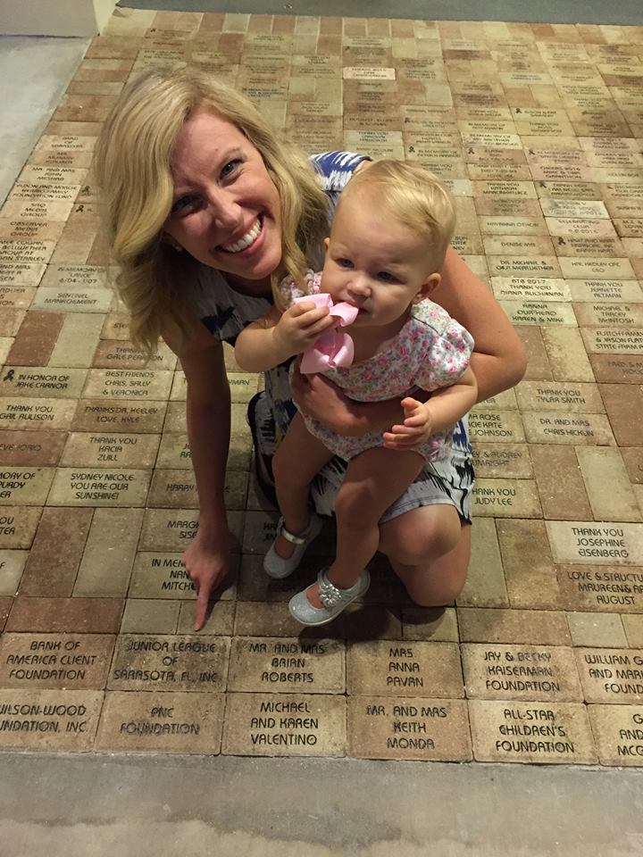 Junior League of Sarasota President Britt Riner with daughter Magnolia Riner next to the The Junior League of Sarasota's brick on the Platinum Pathway of Hope  — Photo courtesy of Britt Riner