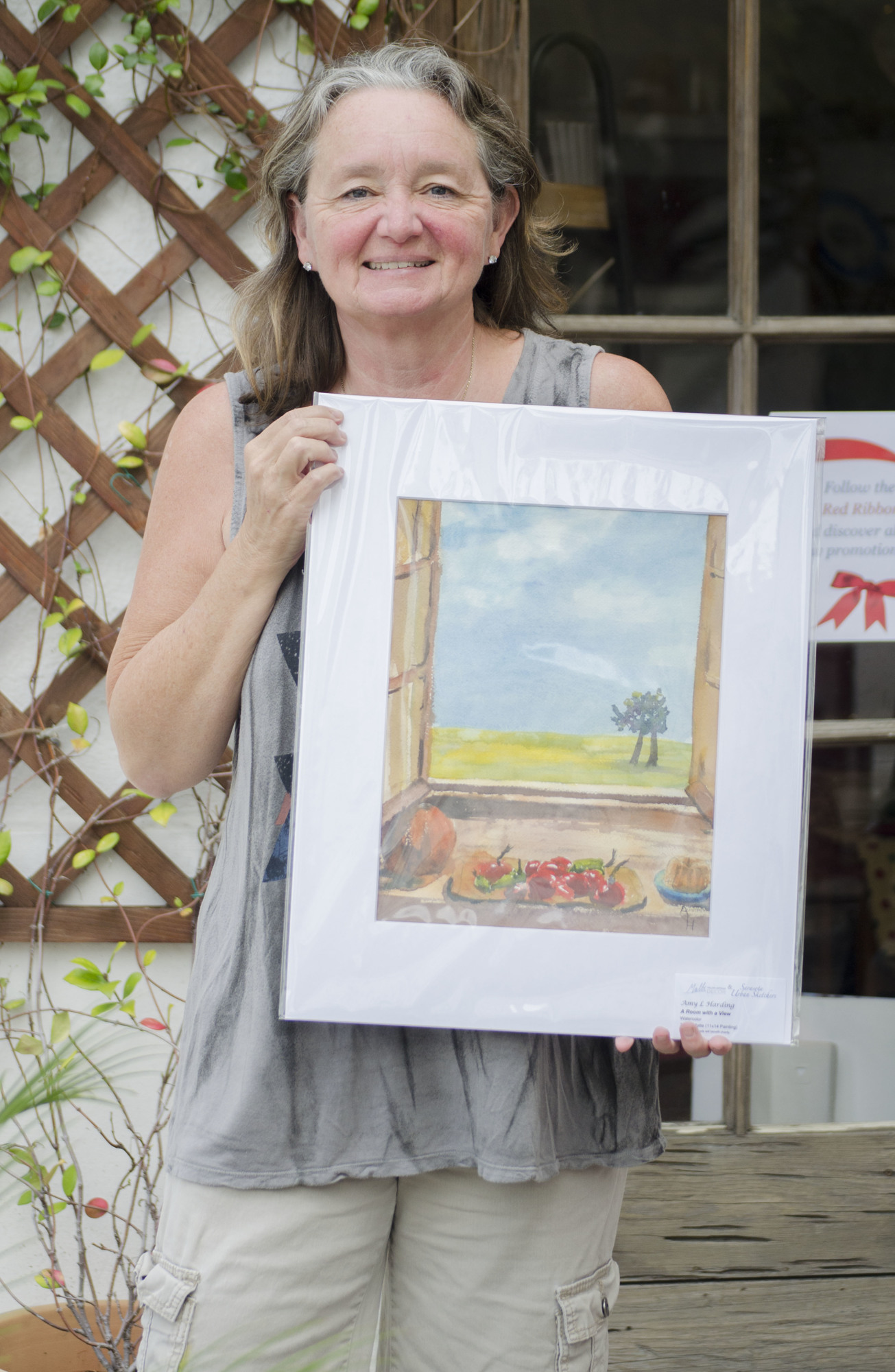 Amy Harding holds one of her submissions to the sale.
