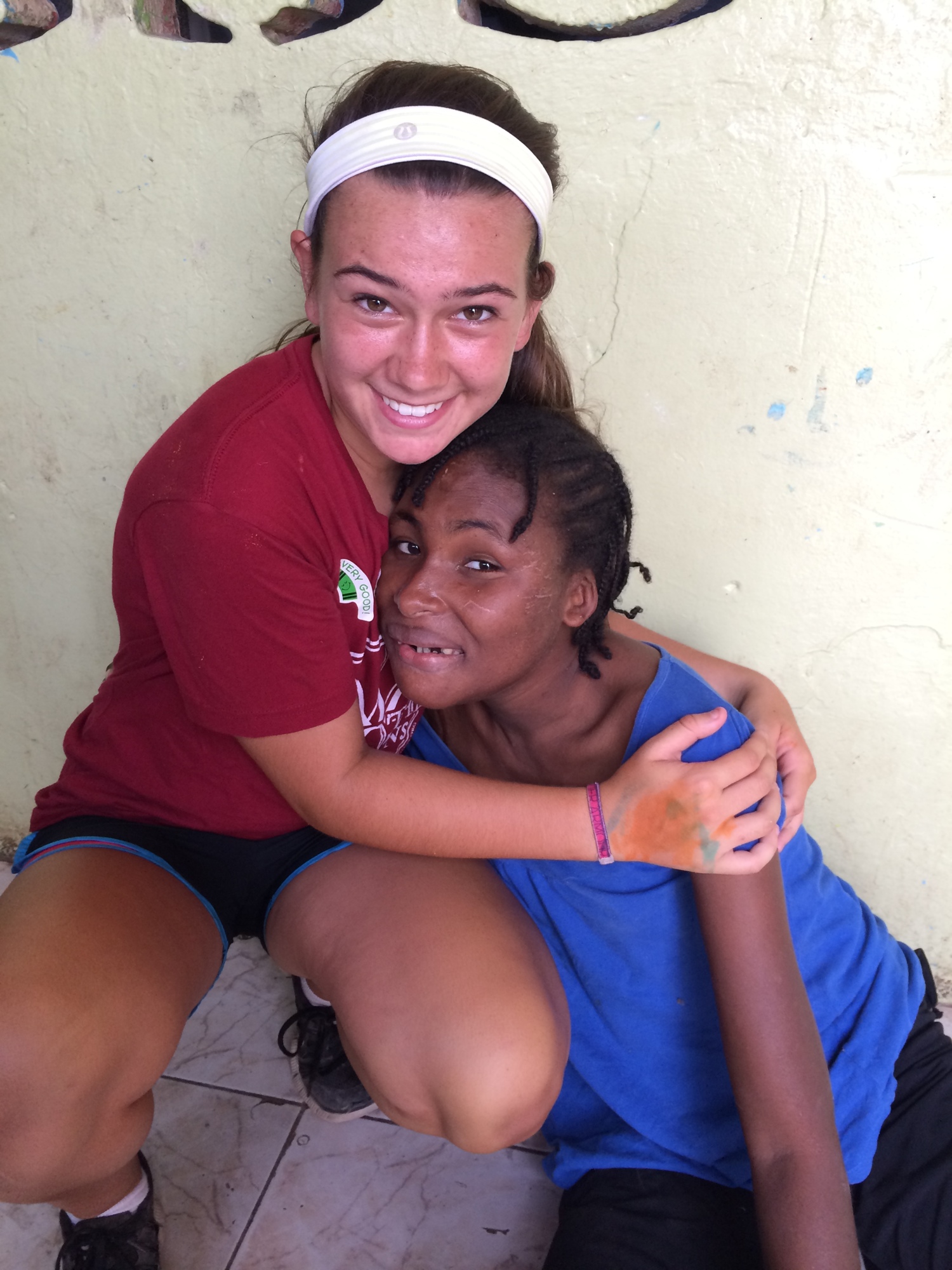 Cardinal Mooney grad and soccer player Isabella McDevitt and Carie pose at Carie's orphanage on the group's June 2015 trip. Courtesy photo.