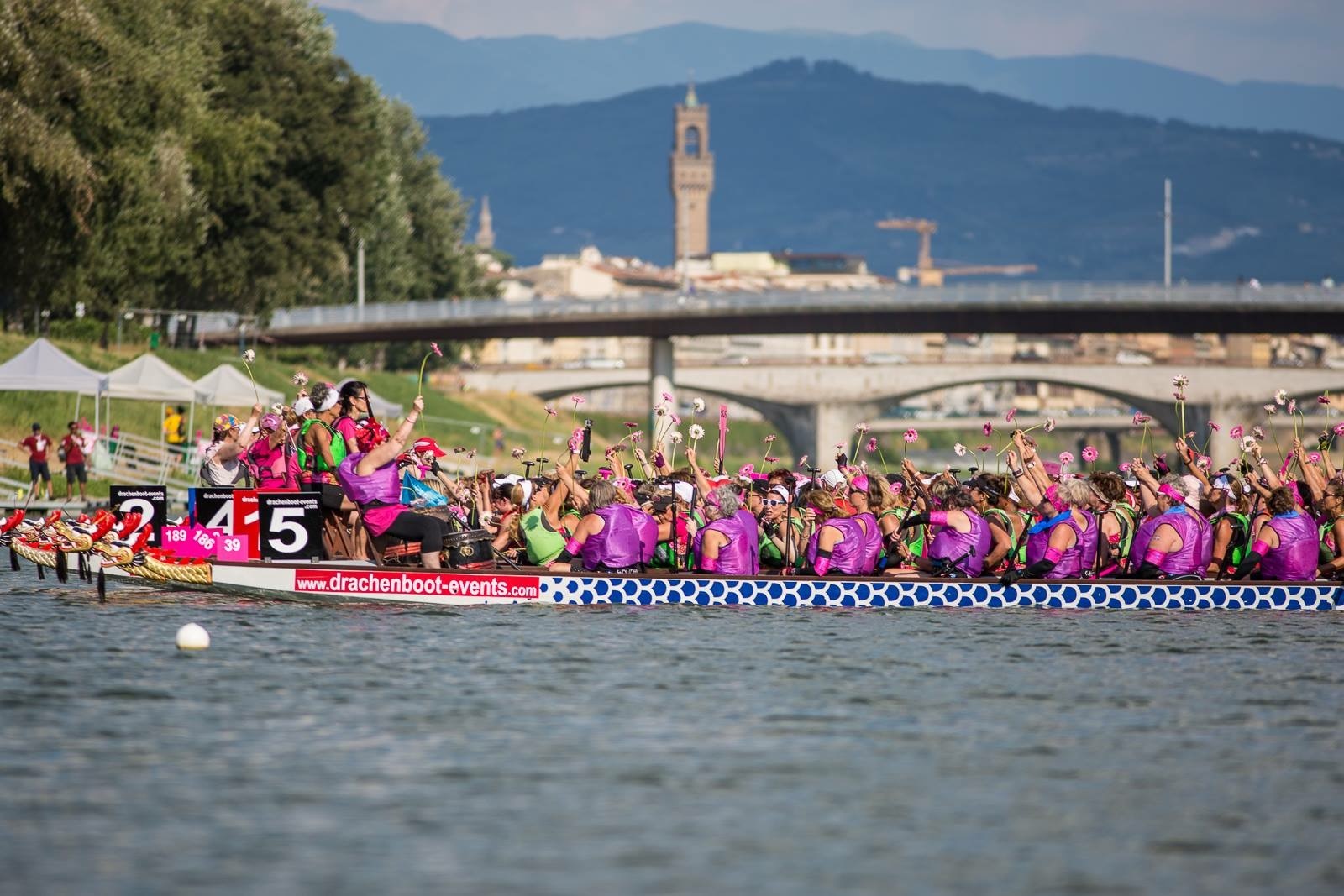 Survivors in Sync holds up flowers during the final ceremony at the  International Breast Cancer Paddlers’ Commission (IBCPC) Participatory Dragon Boat Festival. Courtesy photo.