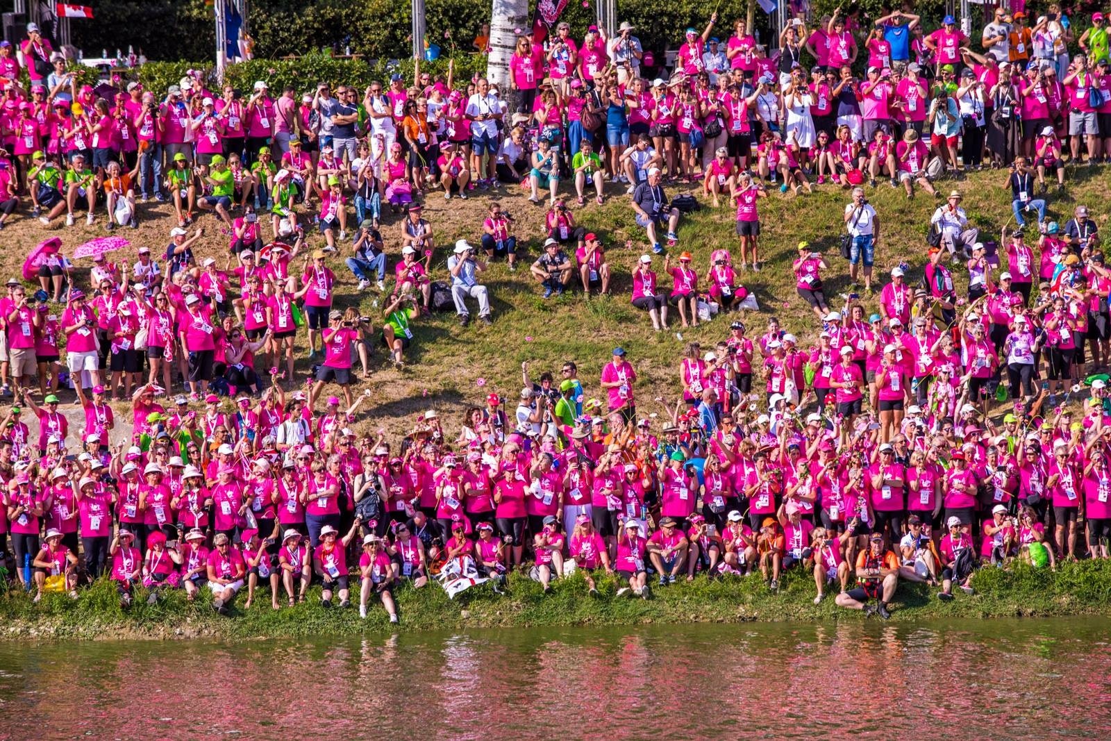 The reflection of the International Breast Cancer Paddlers’ Commission (IBCPC) Participatory Dragon Boat Festival crowd's shirts turn the Arno River pink. Courtesy photo.