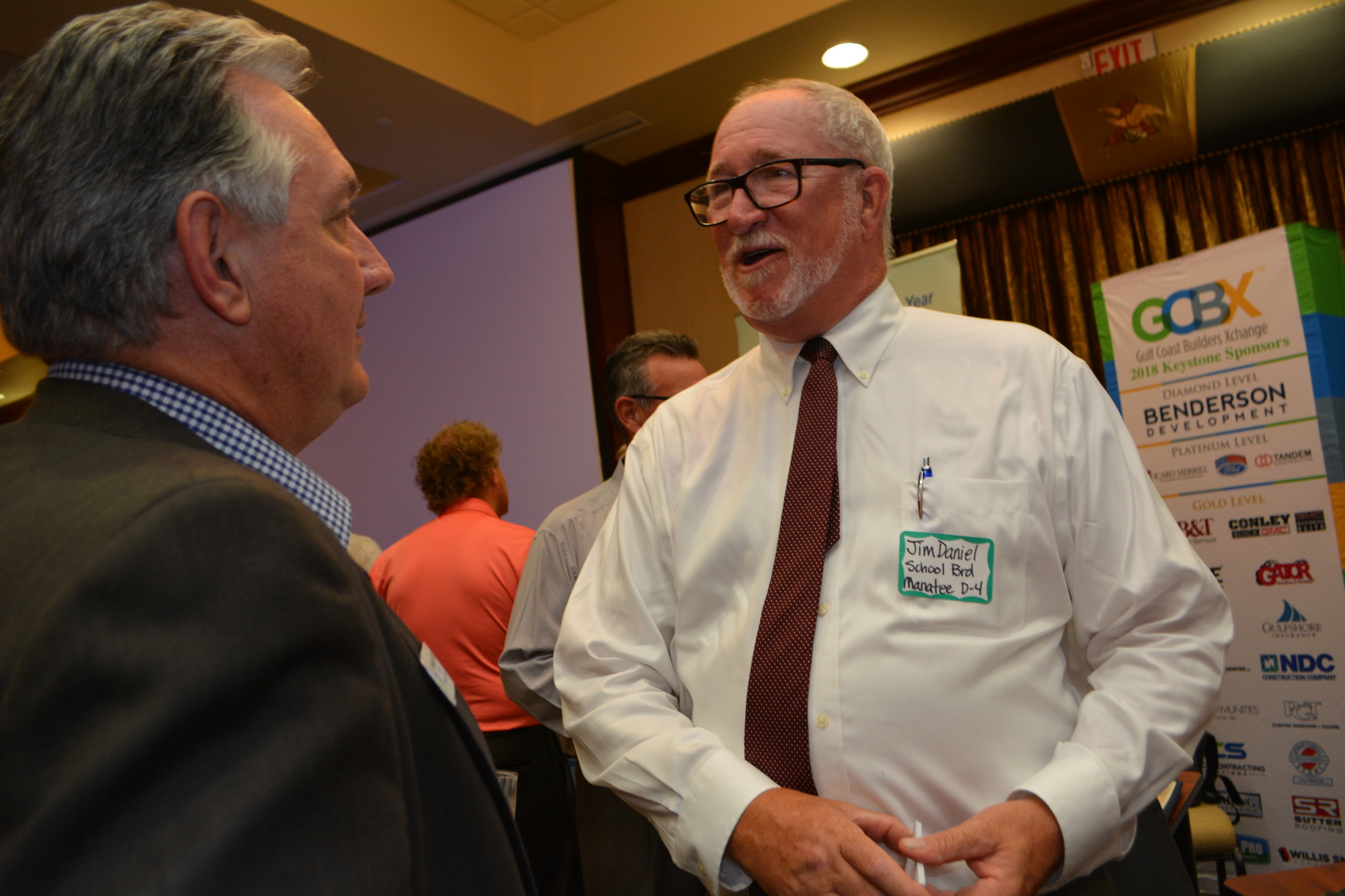 Manatee County School Board candidate Jim Daniel, right, talks with guests about his vision.