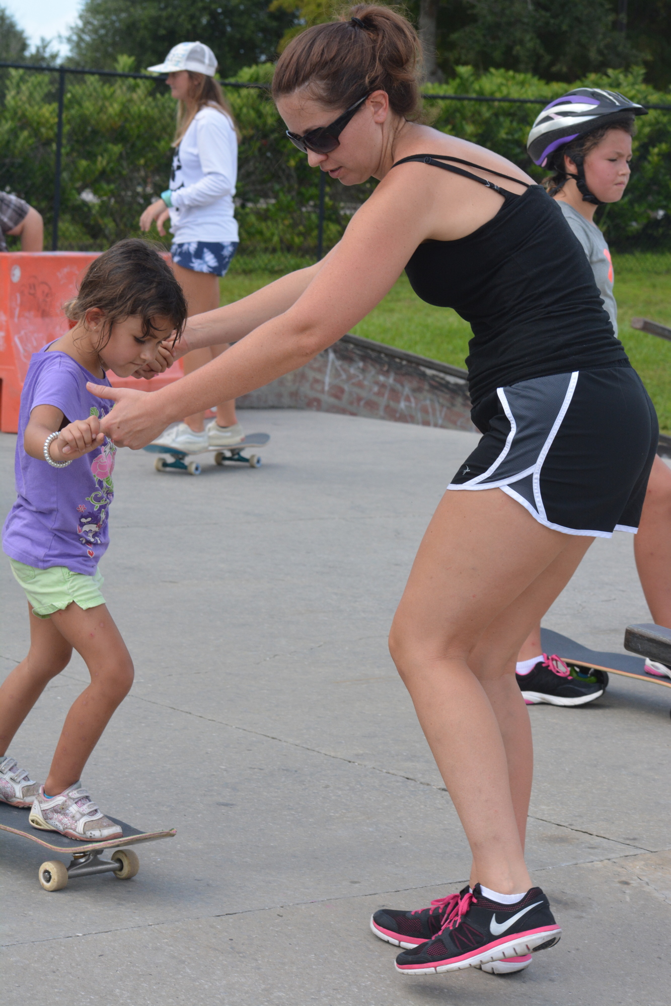 Annika Lemon and mom Amy Lemon learn to stay upright at Payne Park's Skate Rising event.