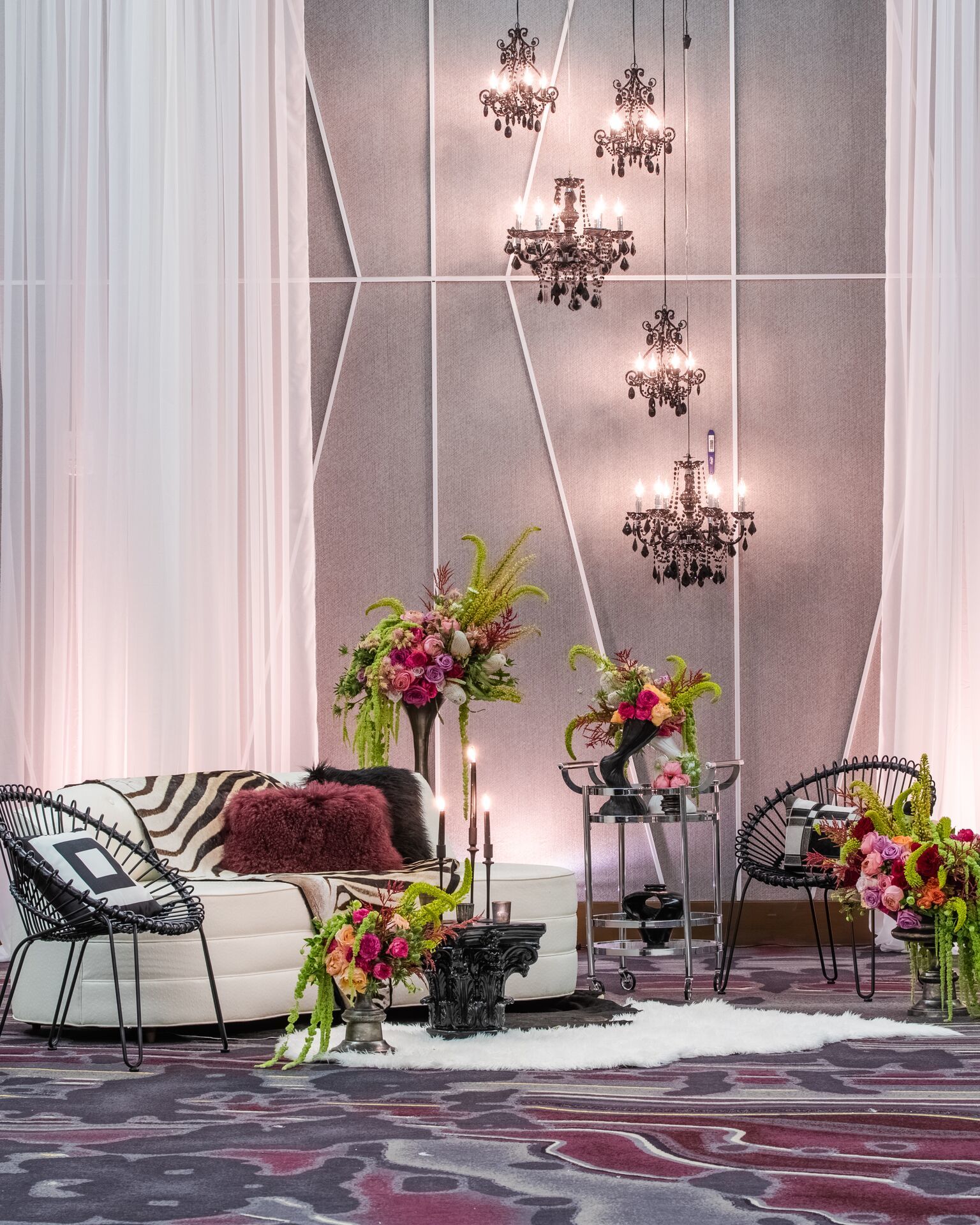 So Staged, along with wedding planner Choreographed Events, set up black and white furniture to make the colored florals pop. Photo courtesy of Dylan Jon Wade Cox Photography.