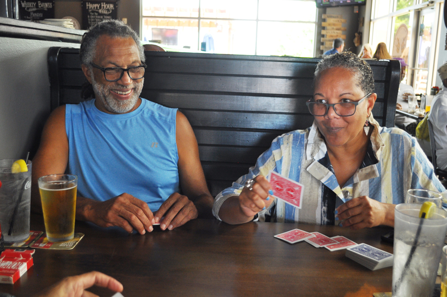 Rasool Jackson and Diane Early try to outdo each other in a round of bid whist.