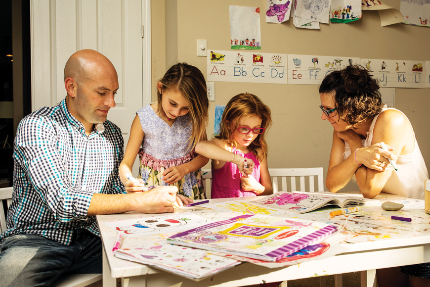 Greenbrook residents Joey and Amy Korenman with their daughters Layla, 7, and Emeline, 6, in the family’s playroom, which doubles as a classroom.