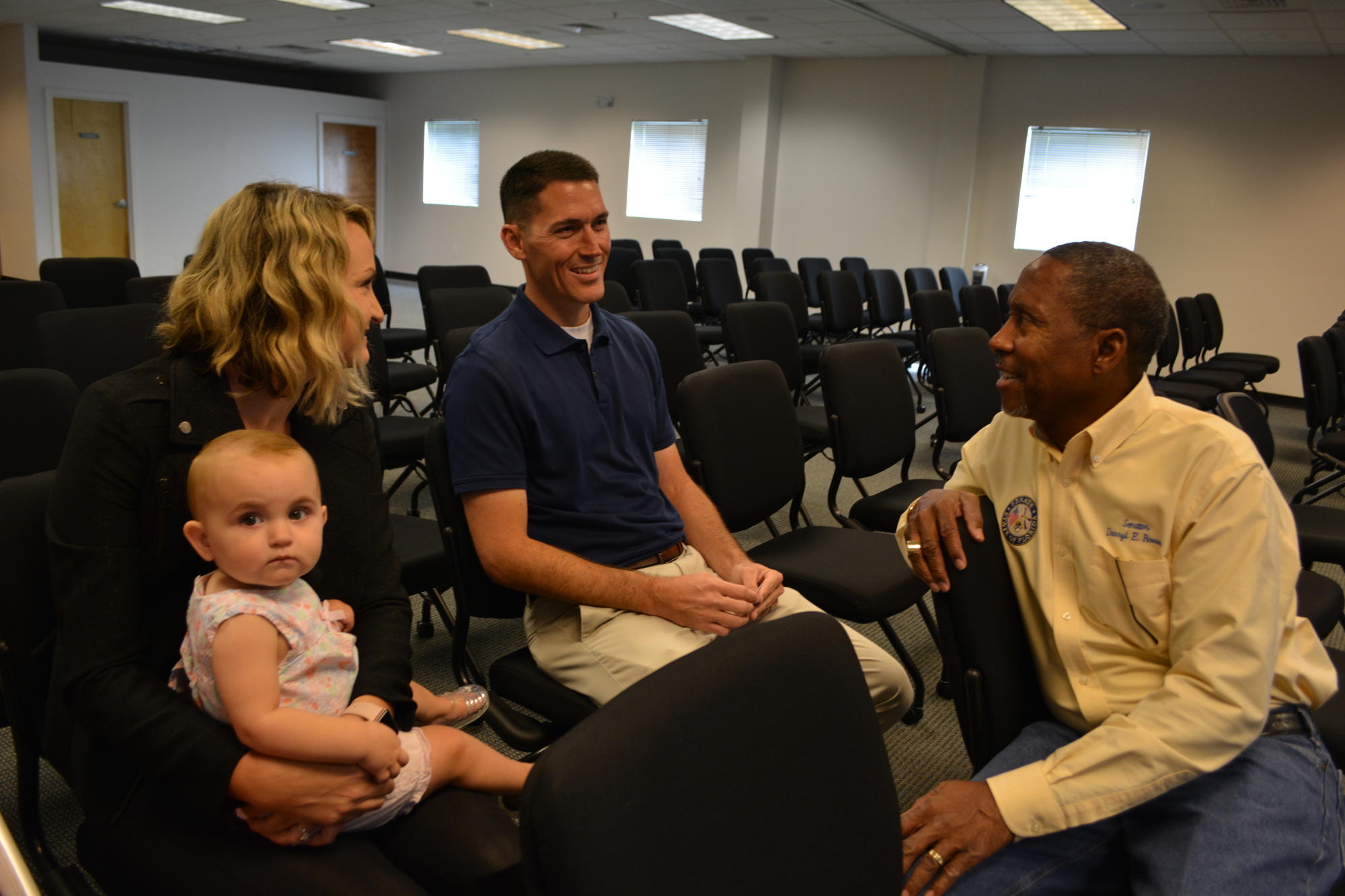Recovered addict Brett Ramsden, pictured with his wife Mallery and daughter Teagan, talks with Florida Sen. Darryl Rouson, a retired addict, before a press conference Sept. 12 about the media campaign. Ramsden story is one of four