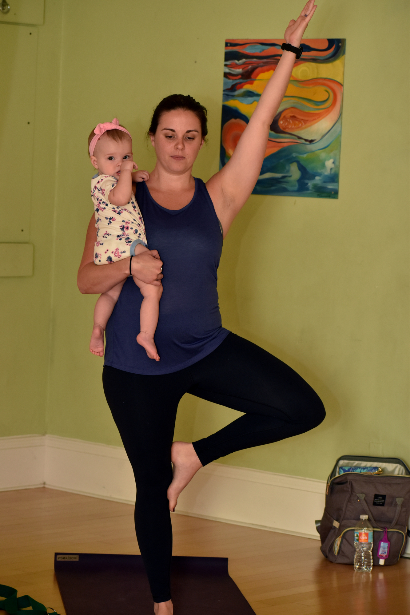 Angelica Ridley  and her daughter Aryana try a pose during a Mommy and Me yoga class.