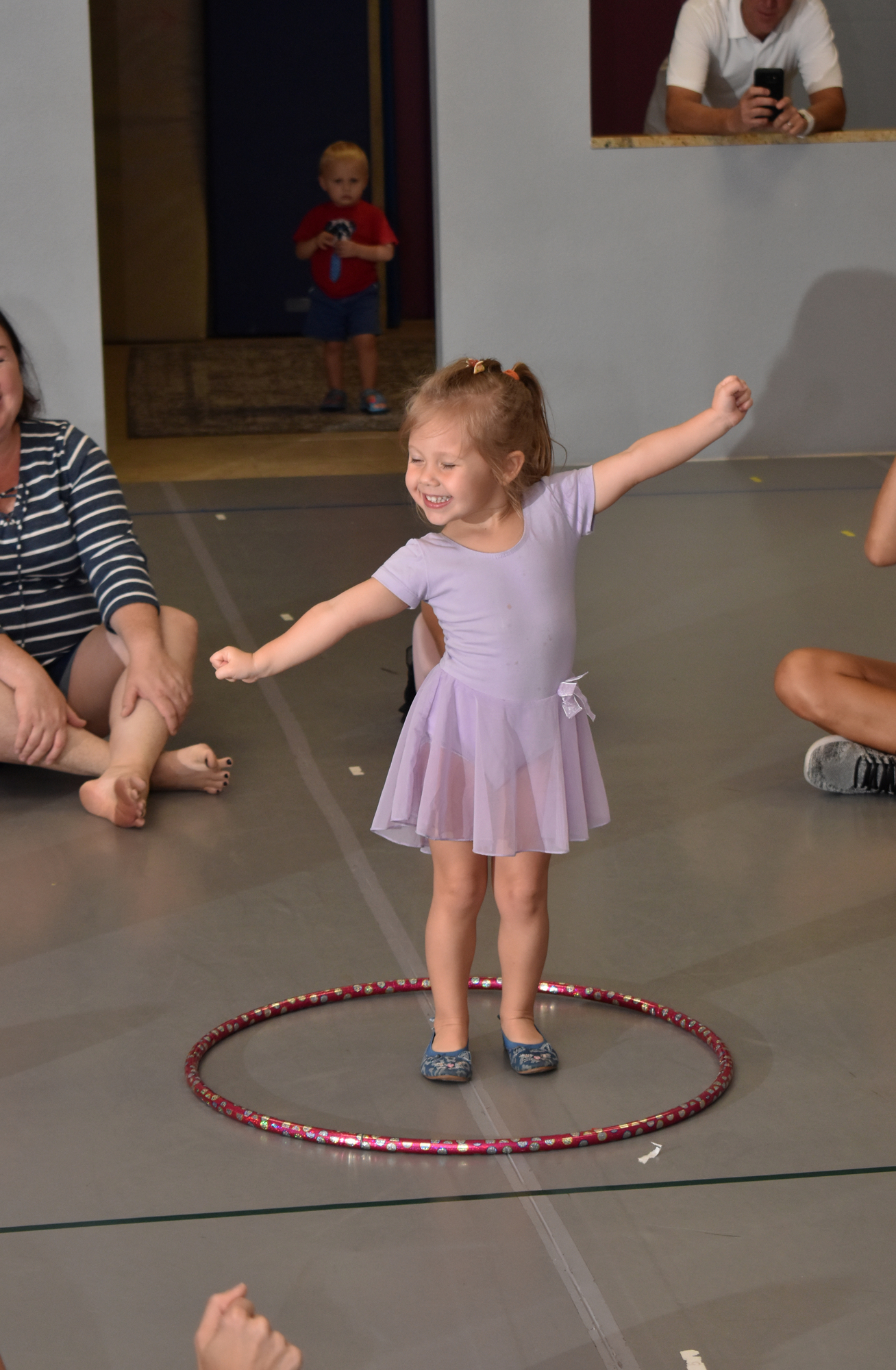 Eva Benson shows off her moves at the end of a Mommy and Me Saturday morning session.