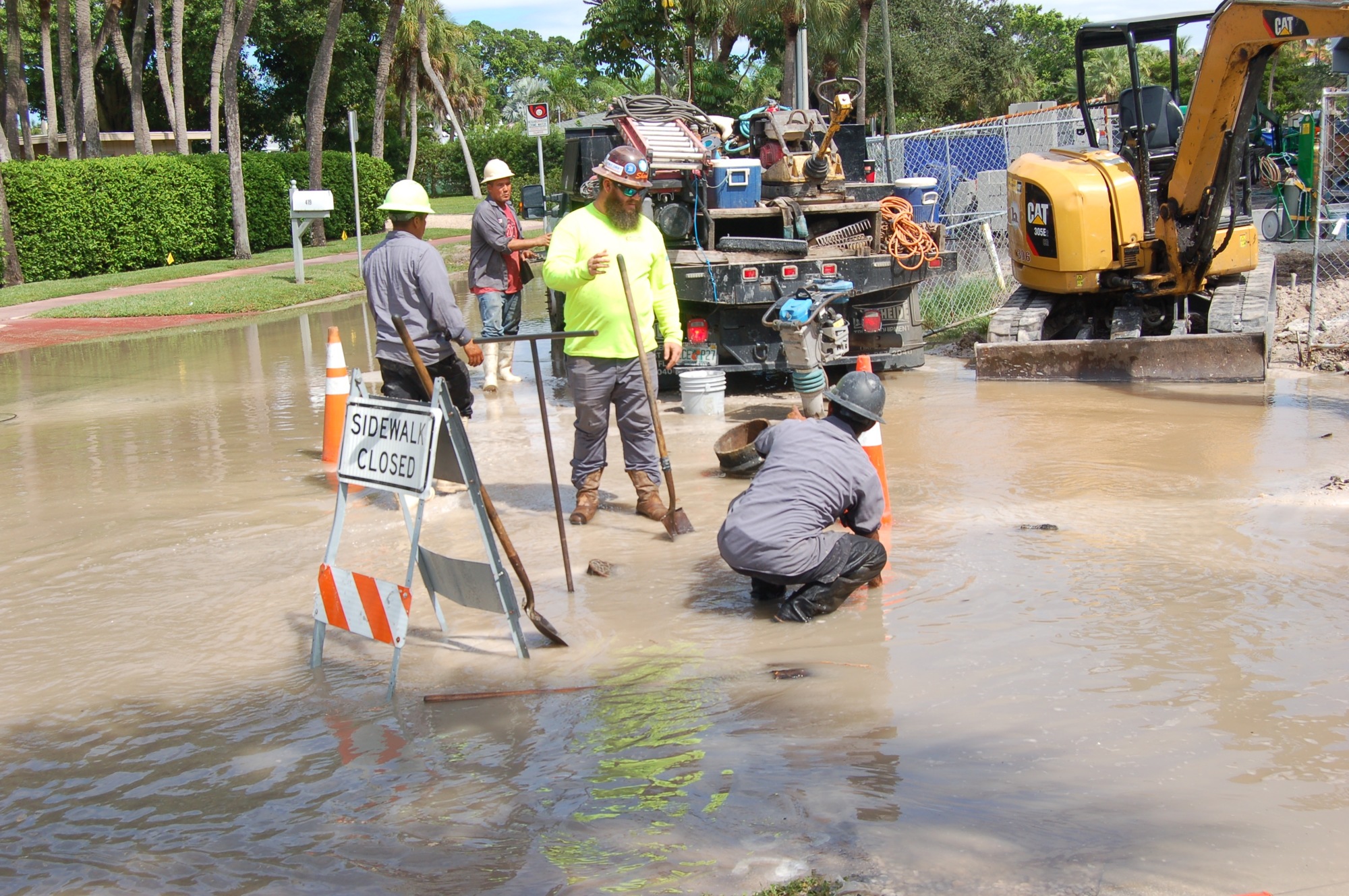 Crews work to cut off the water after a pipe break near the site of the St. Armands Circle parking garage construction project.