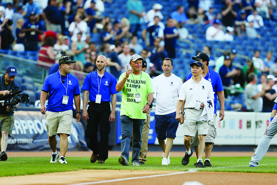 Richard Albero takes the final steps in his 1,200-mile journey from home plate at Tropicana Field to home plate at Yankee Stadium, accompanied by members of the Wounded Warrior Project.