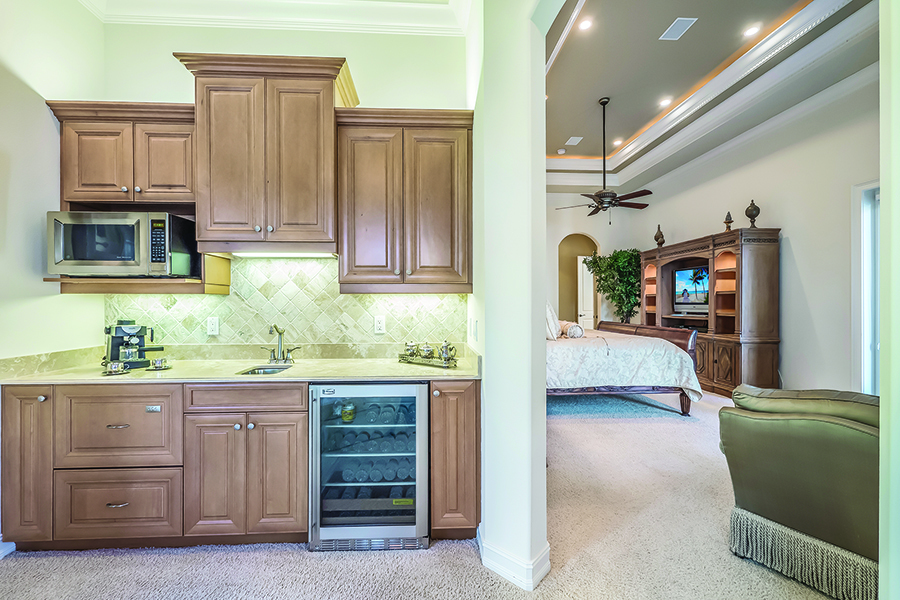 A tucked away wet bar, complete with mini-dishwasher, is perfect for early morning coffee.