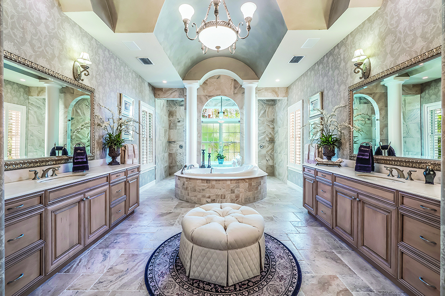 The elegant master bath features a vaulted ceiling and a walk-in double shower behind the free-standing tub.