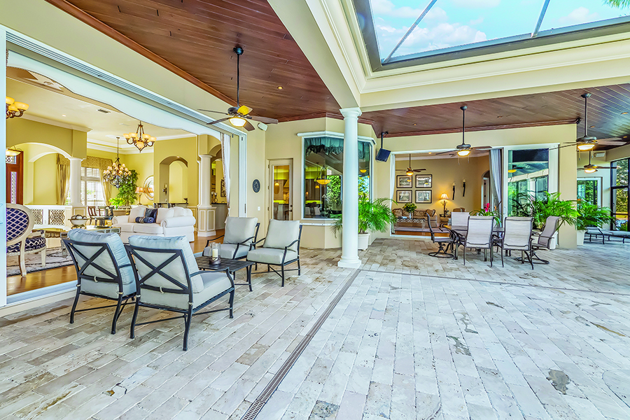 Glass doors slide back to double the home’s living space, with outdoor seating and dining.