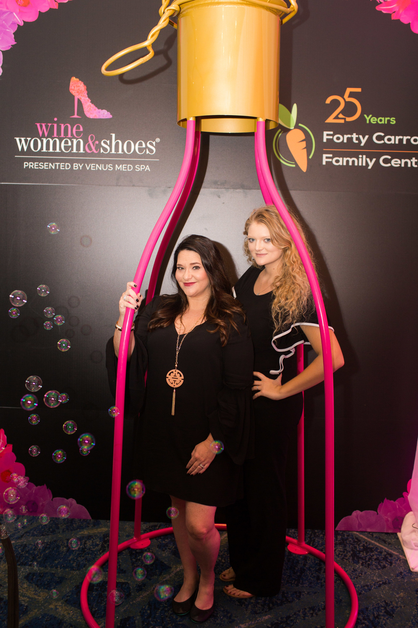 Amy Hammon and  Rachael Laughlin in the Hello Gorgeous photo booth at Wine, Women & Shoes Nov. 9. The photo booth for this event was made by the Tube Dude.