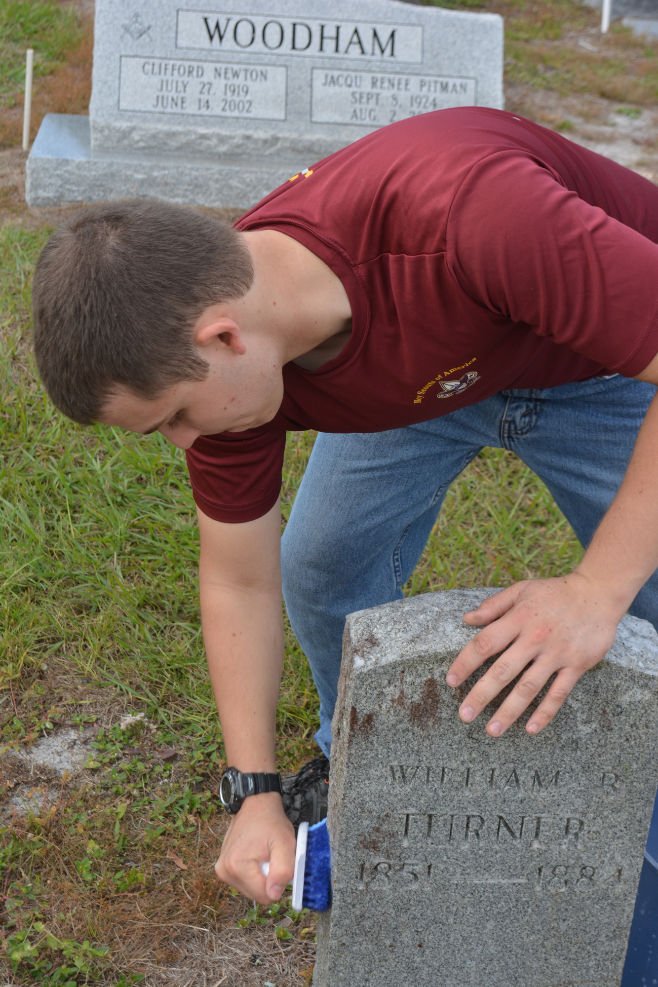 Lakewood Ranch's Samuel Yunker, a member of Troop 89, cleans a headstone.