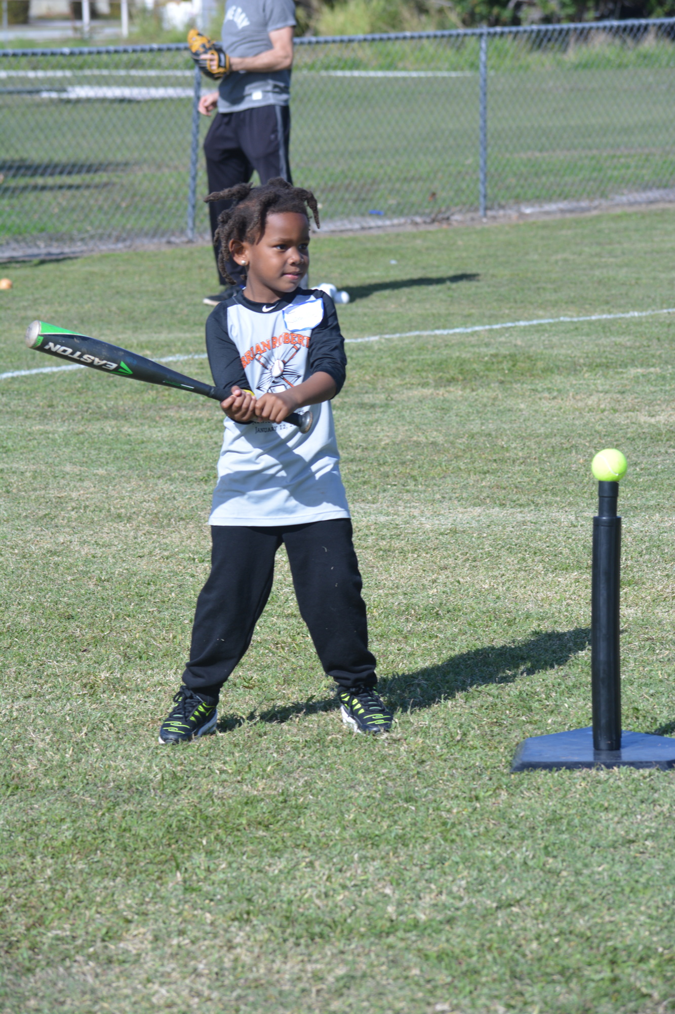 Jamille Brown, 5, readies to take a big swing at the tee ball station during the clinic.