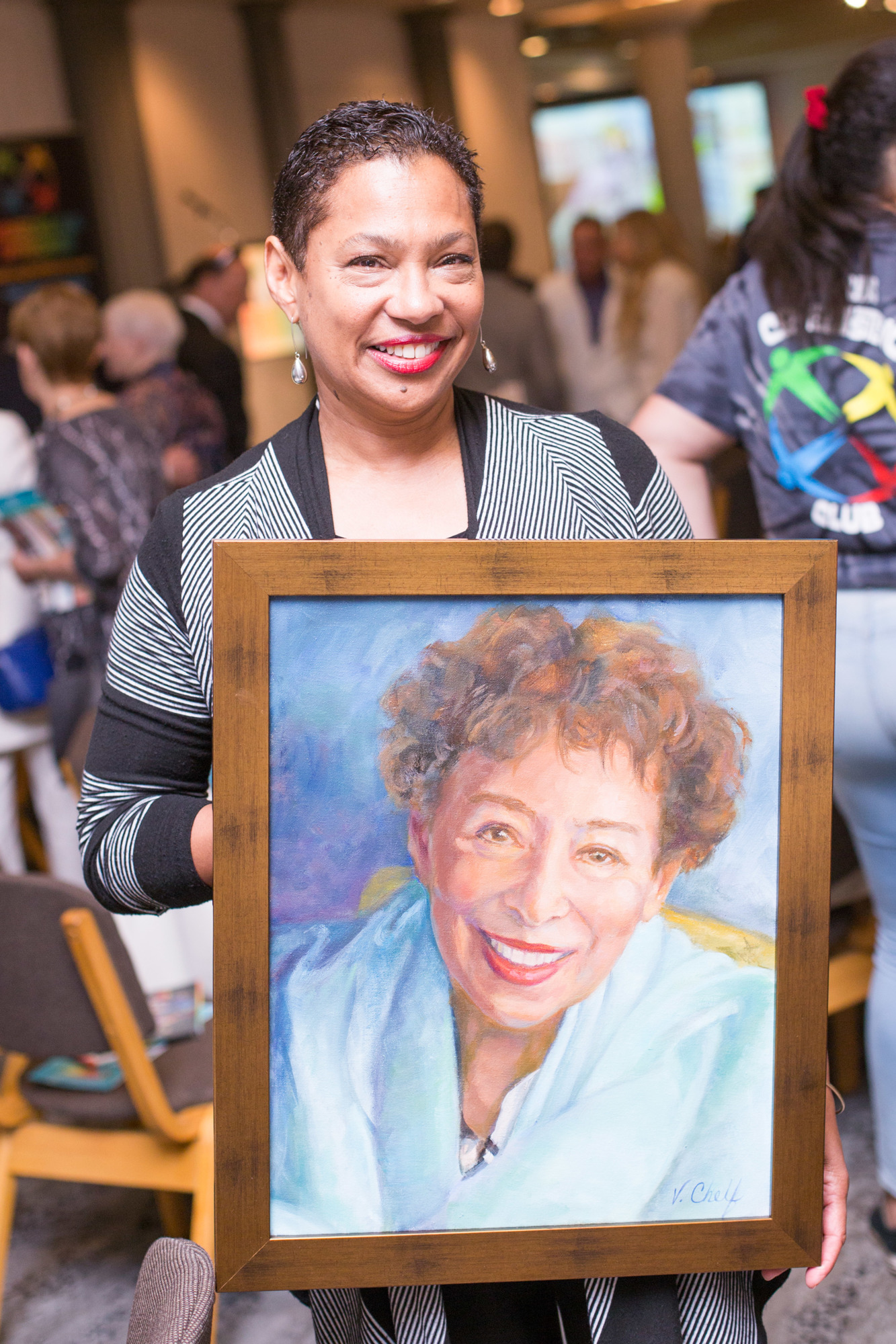 Linda Poteat-Brown holds up a portrait of her mother, Carol Poteat-Buchanan.