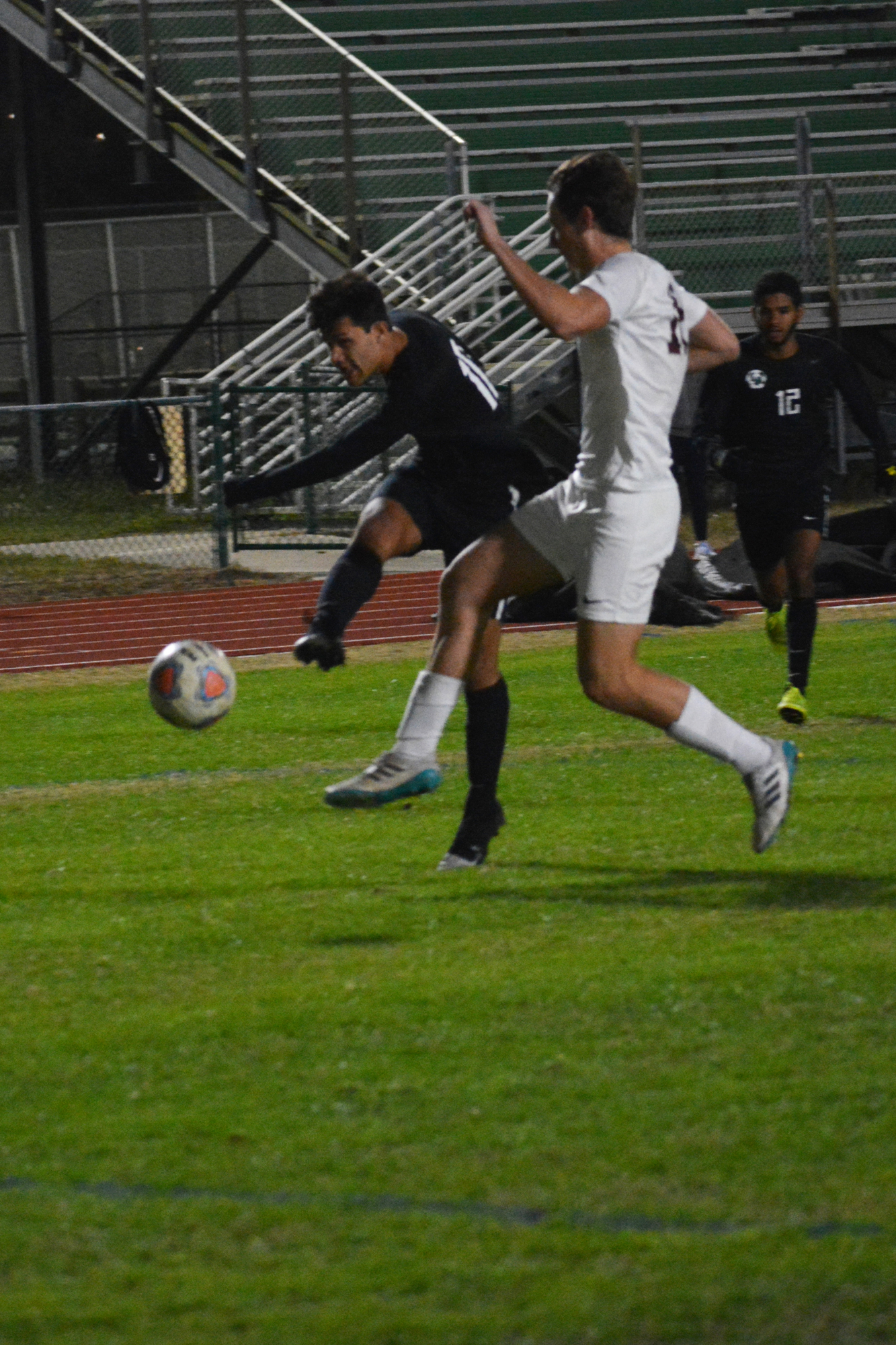 Senior forward Wilmer Yanez, whose family is from Honduras, boots a ball at the Riverview net.