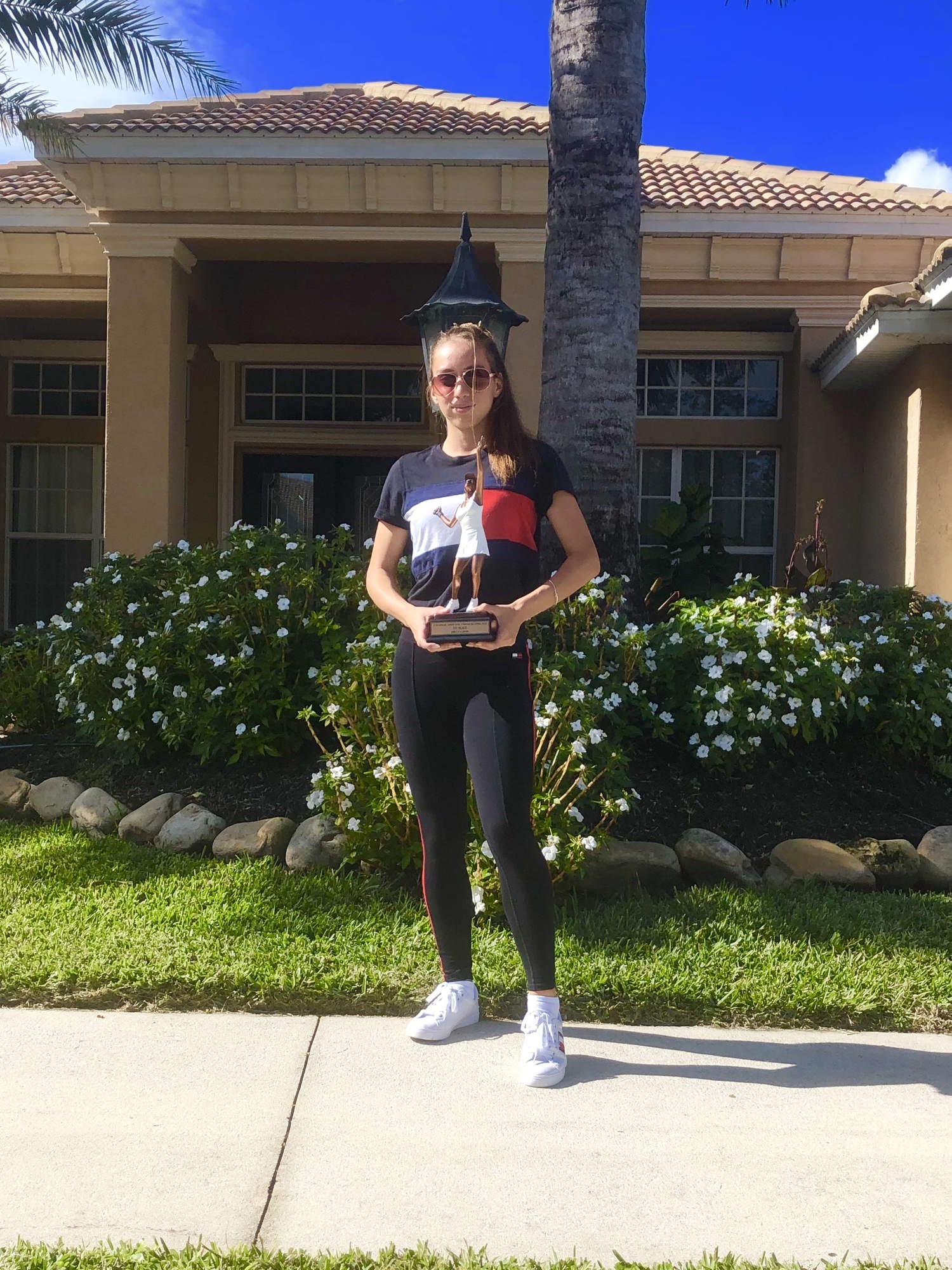 Sarasota's Nikki Yanez, here posing with her USTA Florida Level 3 Singles trophy, has won nine of her last 10 tournaments. Photo courtesy Paul Yanez.