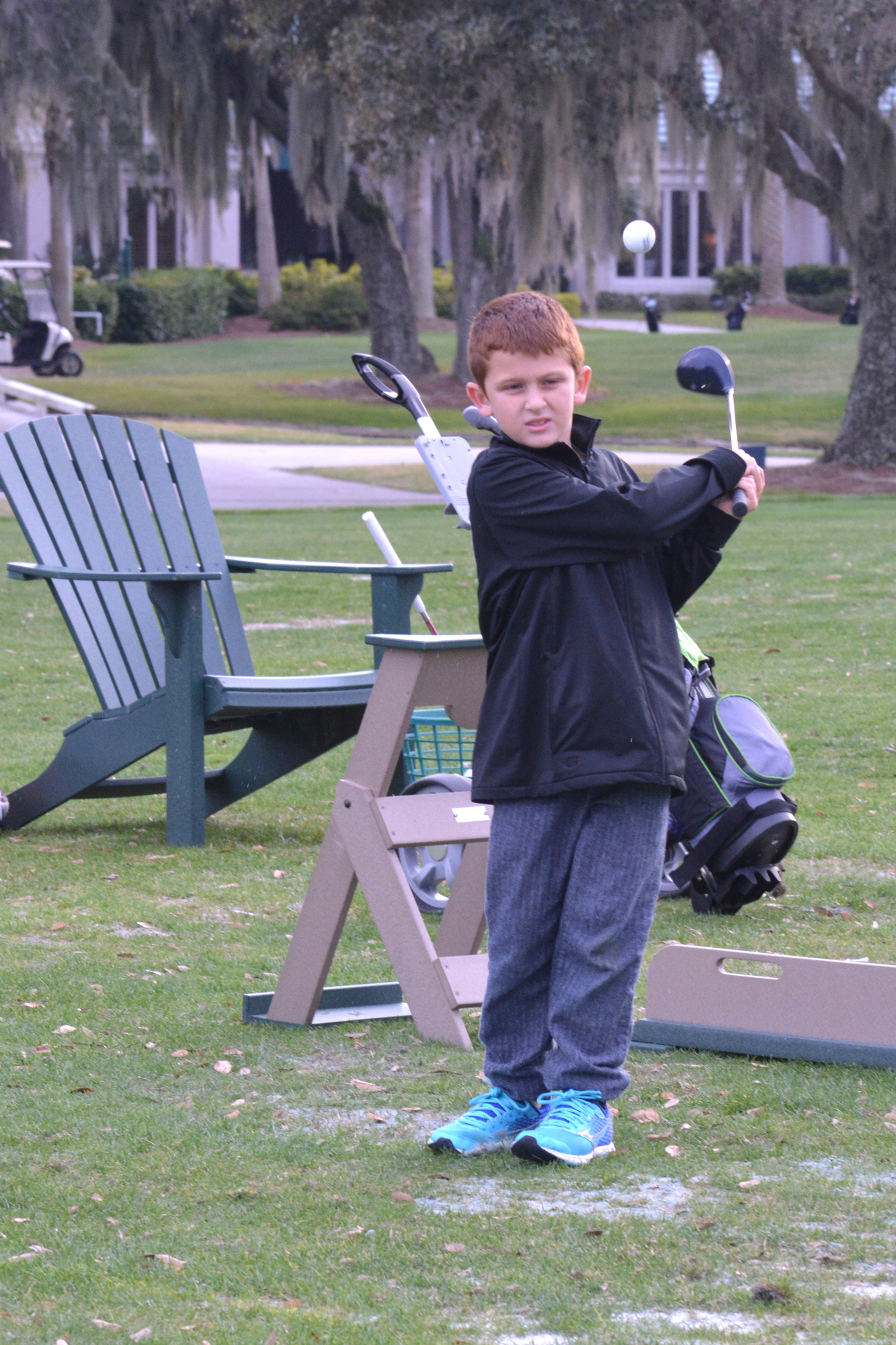 Benjamin hits balls during The First Tee's Birdie class at Rosedale Golf and Country Club.