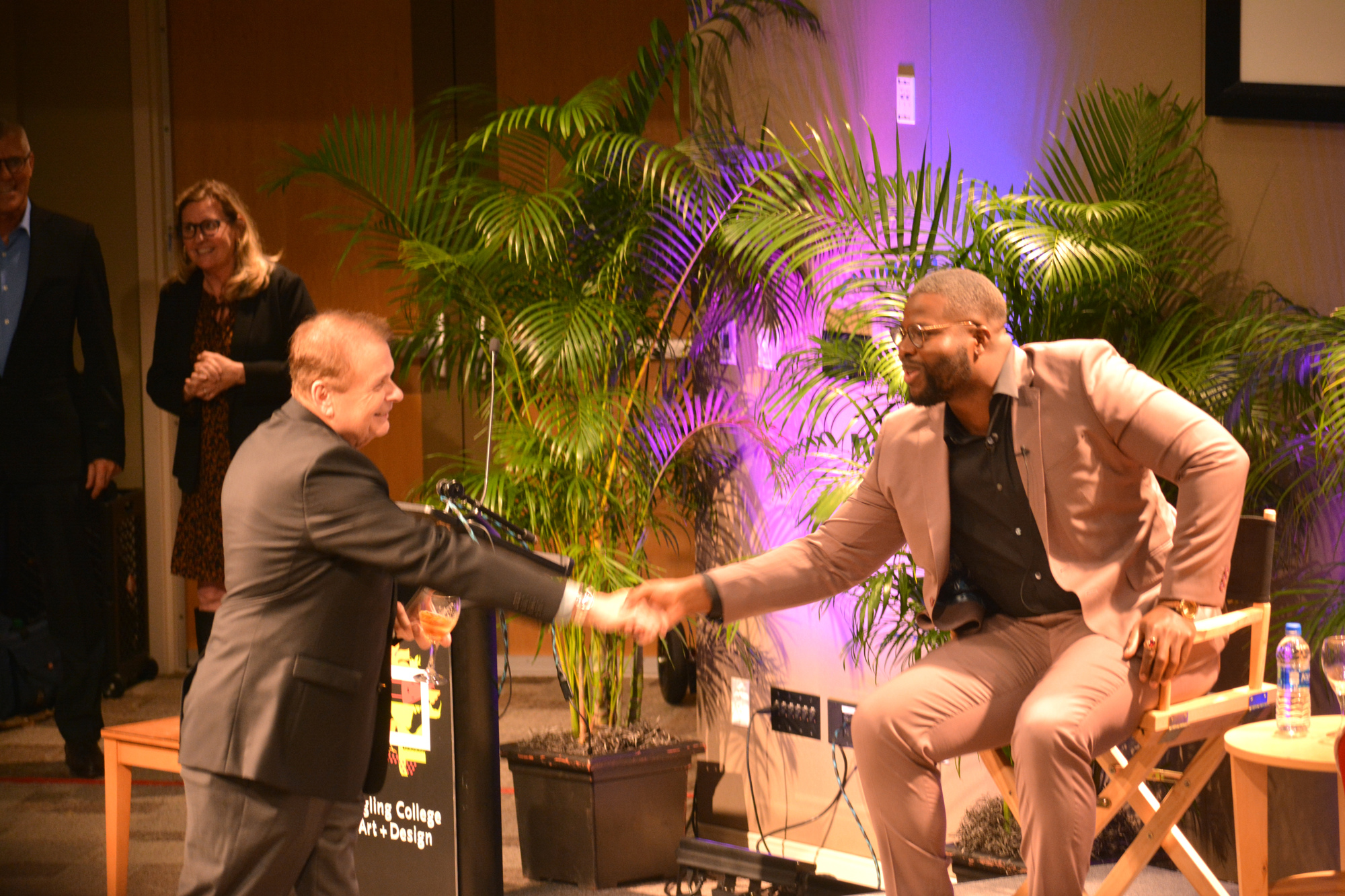 Larry Thompson and Winston Duke shake hands before Duke speaks to the Q&A audience at Ringling College of Art and Design.