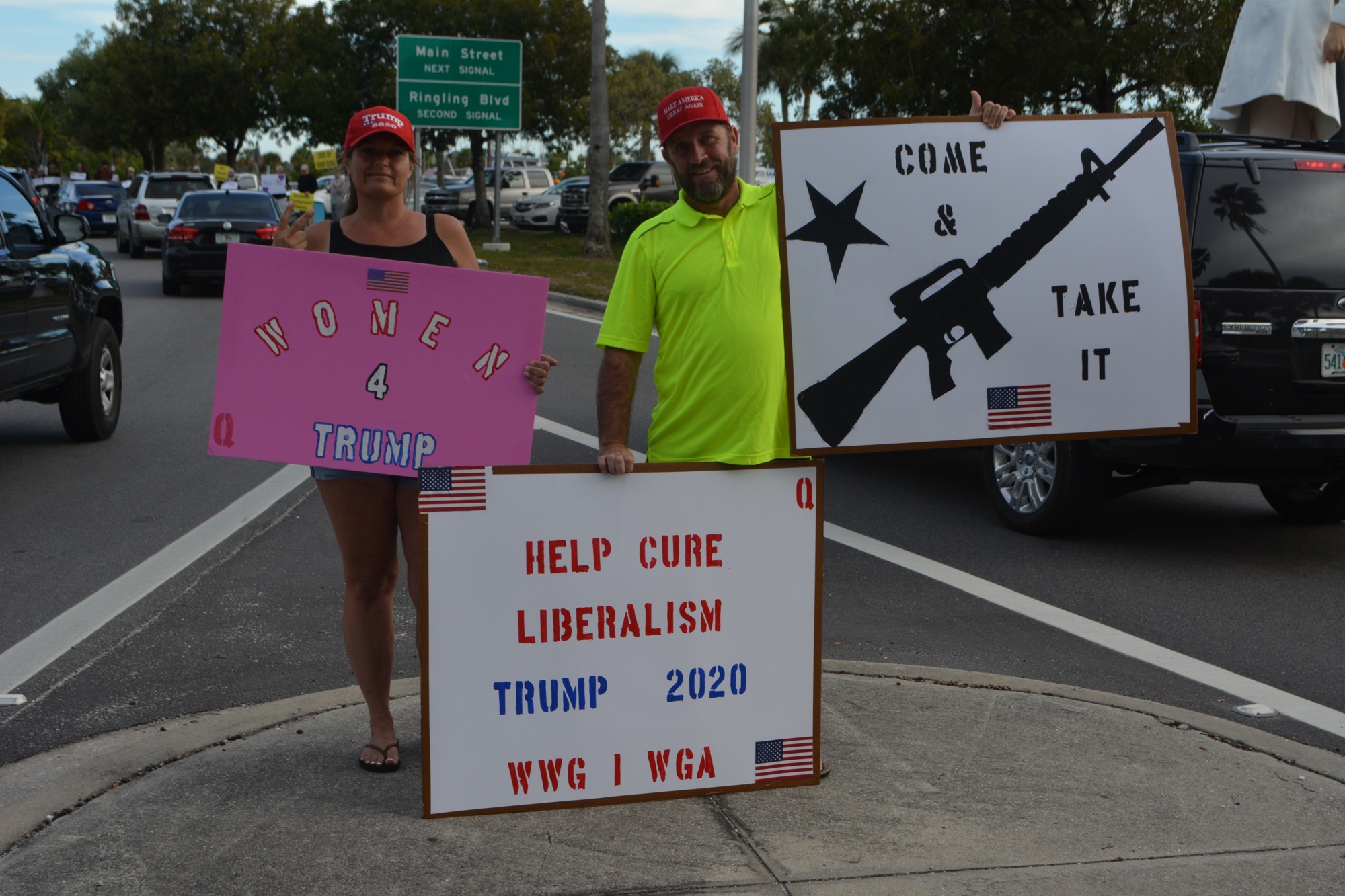 Tom and Susan Caparell hold their signs down the street from the Brady Campaign attendees.