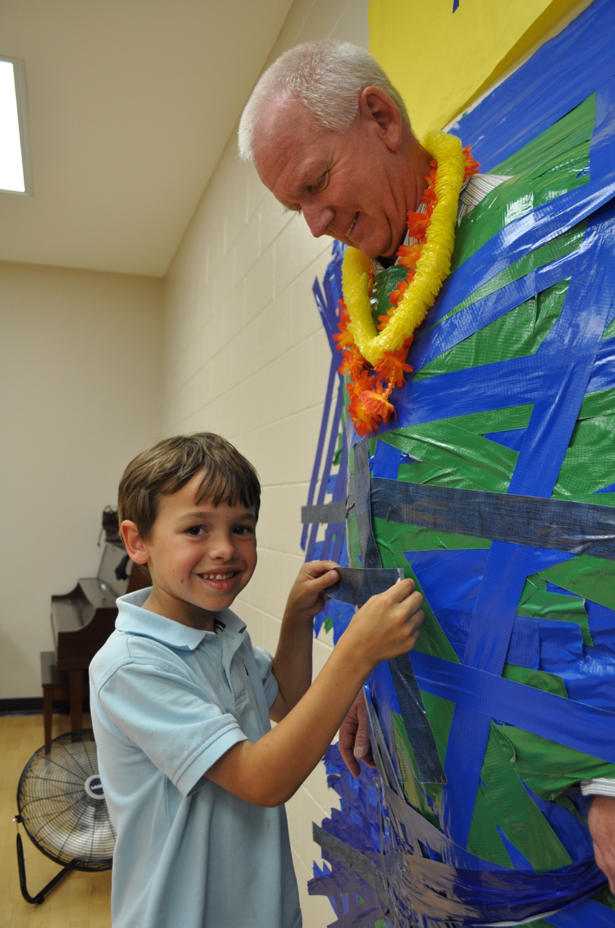 Willis Elementary principal Bill Stenger gets duct taped to the wall by student Nathan Green in 2013. File photo.