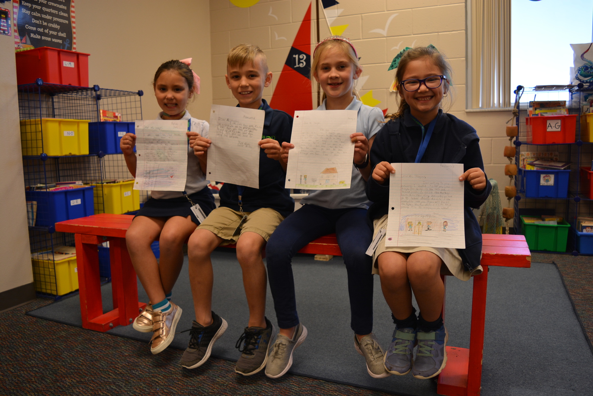 Second-grade teacher Laurie Rahn's students Ava Sarid, Tucker Briggs, Mia McLaughlan and Emilia Gonzalez show off letters they wrote to Principal Bill Stenger as part of a 