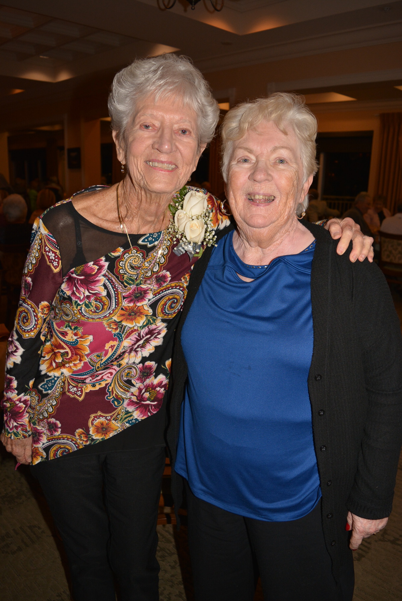 Tara Golf and Country Club's most veteran resident Helen Kunzman wears a corsage during the March 2 dinner celebration. She stands beside friend Jeanne Smith. Kunzman moved to Tara in 1989. Smith came 14 years ago.