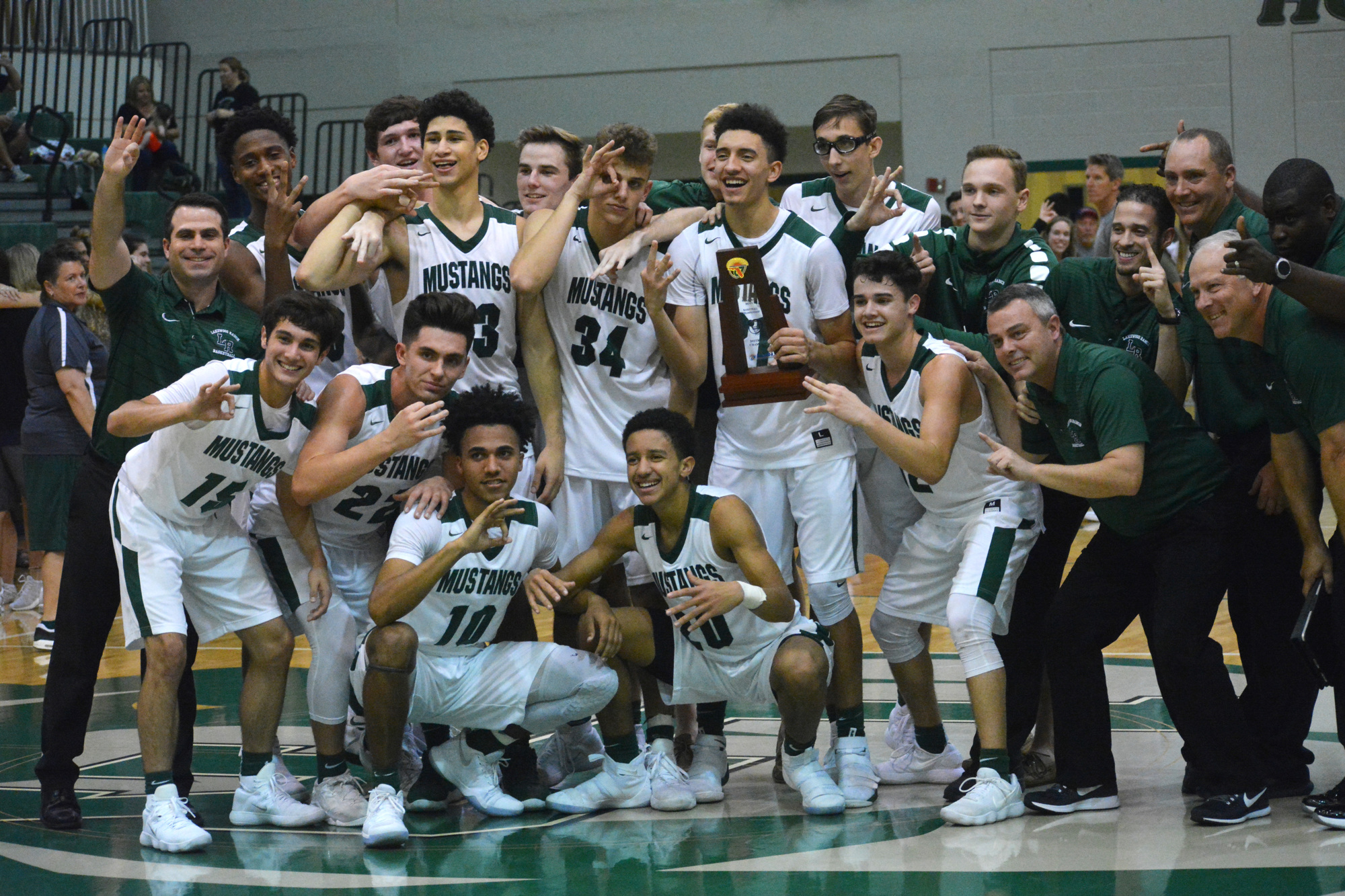 Jack Kelley (34) and his Lakewood Ranch High teammates celebrate a district title victory in 2017-2018.