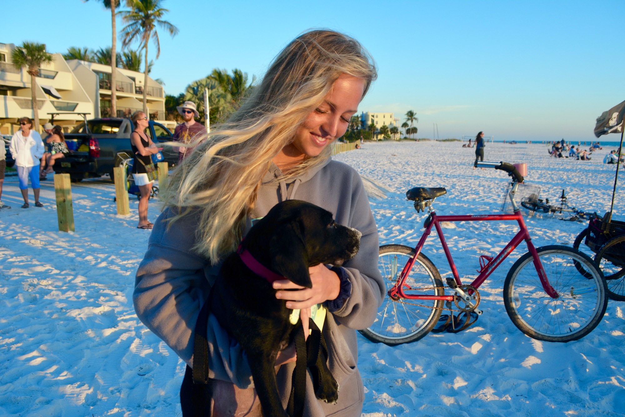 Lauren Dougherty enjoys a sunset with her black lab puppy, Kya.