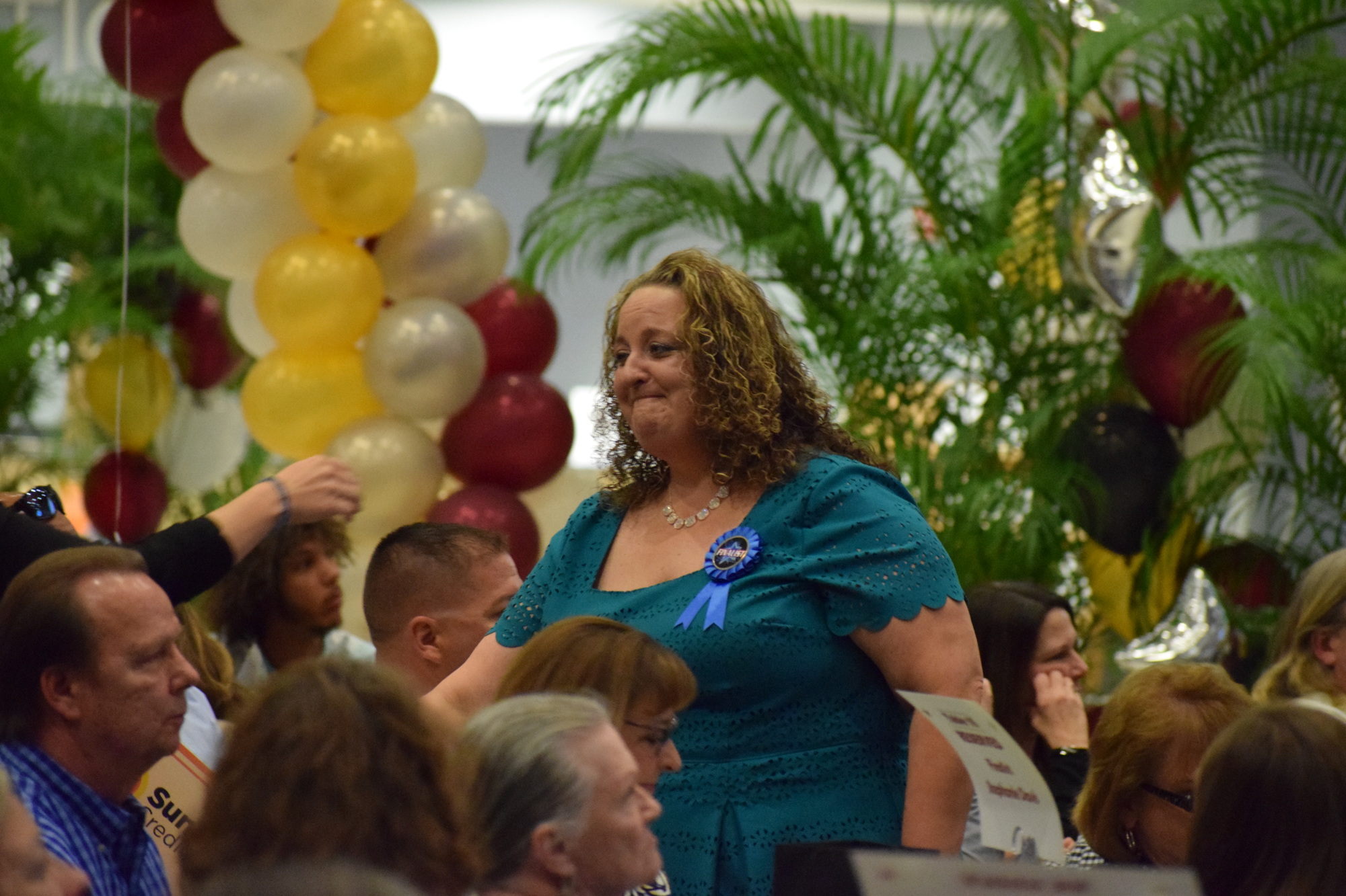 After winning the Support Employee of the year award, an emotional Amanda Keeney makes her way through the crowd back to her seat.