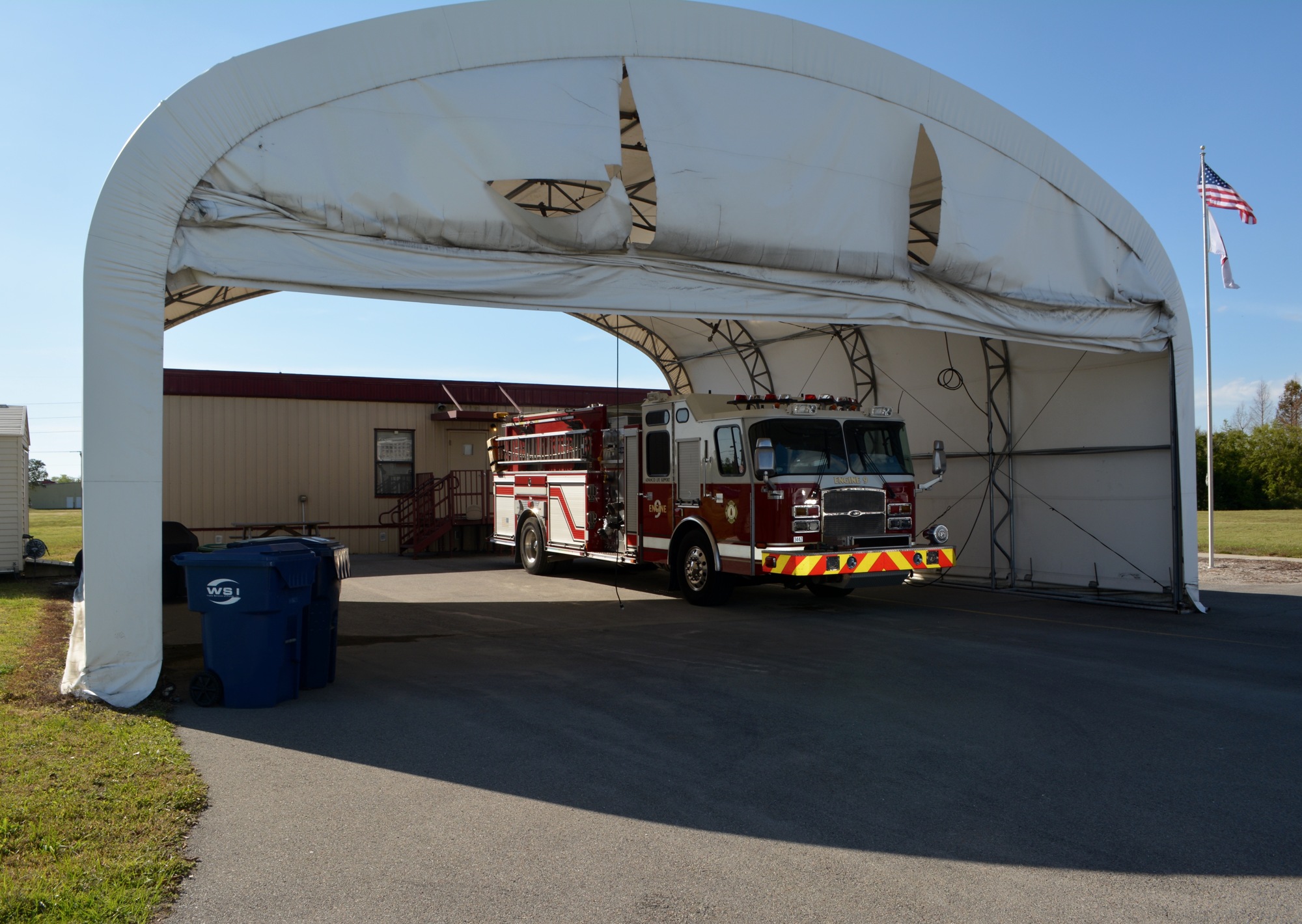 The station on Apex Road is currently comprised of a large white tent and metal portable building.