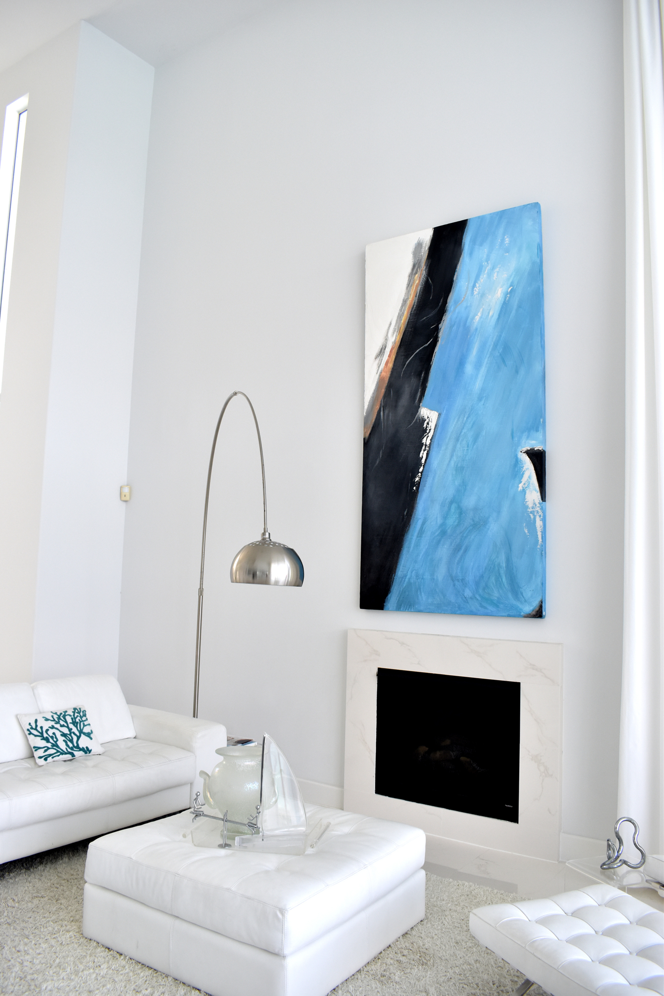 A blue abstract piece splashes the mid level of the Gerich home.