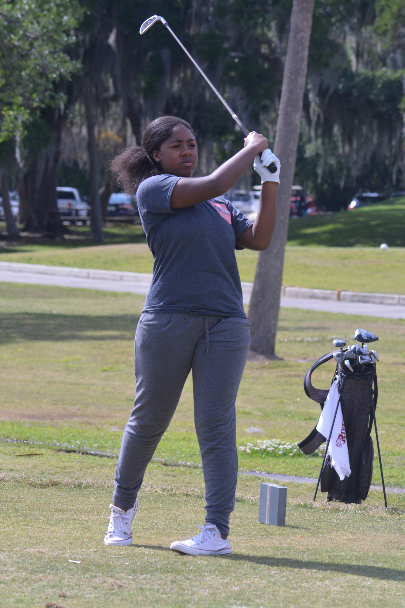 Jocelyn Parker watches her shot fly on the first hole at Bobby Jones Golf Club.