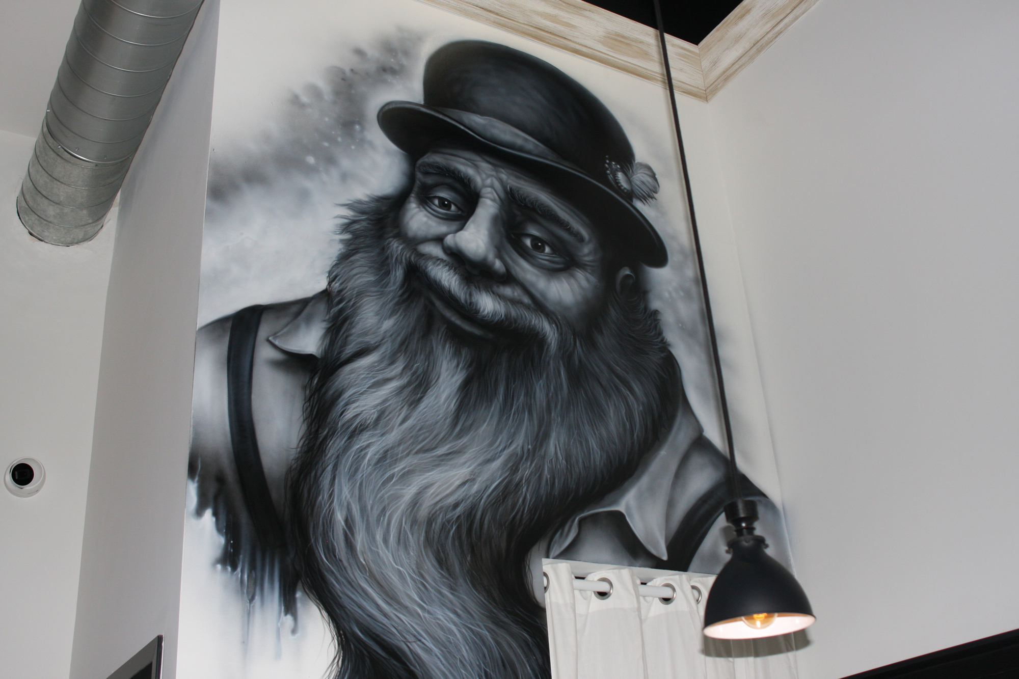 A large mural of a the bar/shop's mascot of sorts greets guests with a friendly smile. Photo by Su Byron
