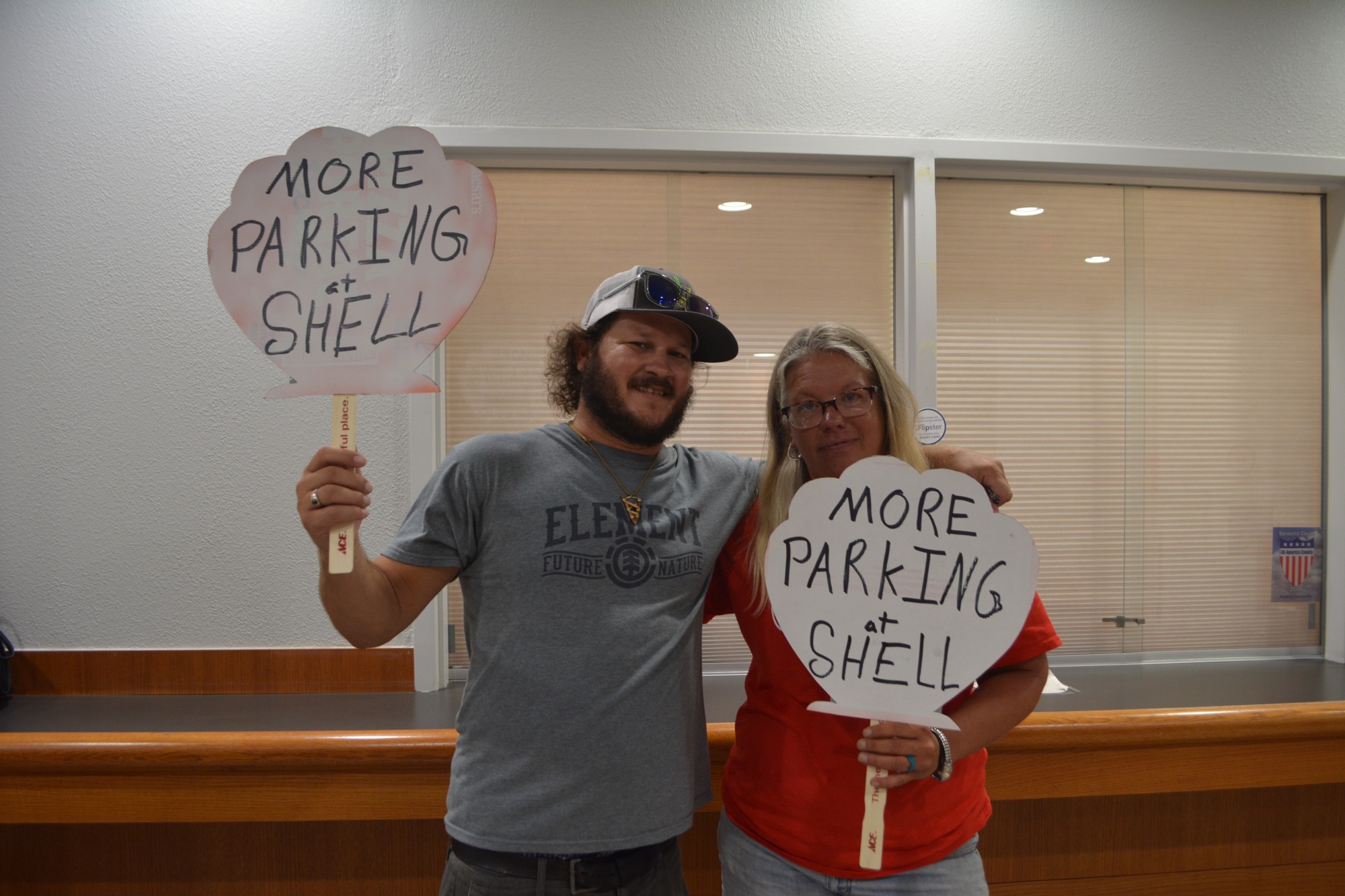 Daniel Fletcher and Eva Anderson were two community members who attended the meeting bearing signs of protest