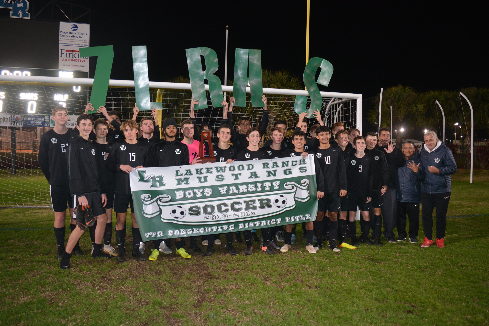 6. The Mustangs hold a banner celebrating their seventh-straight district title.