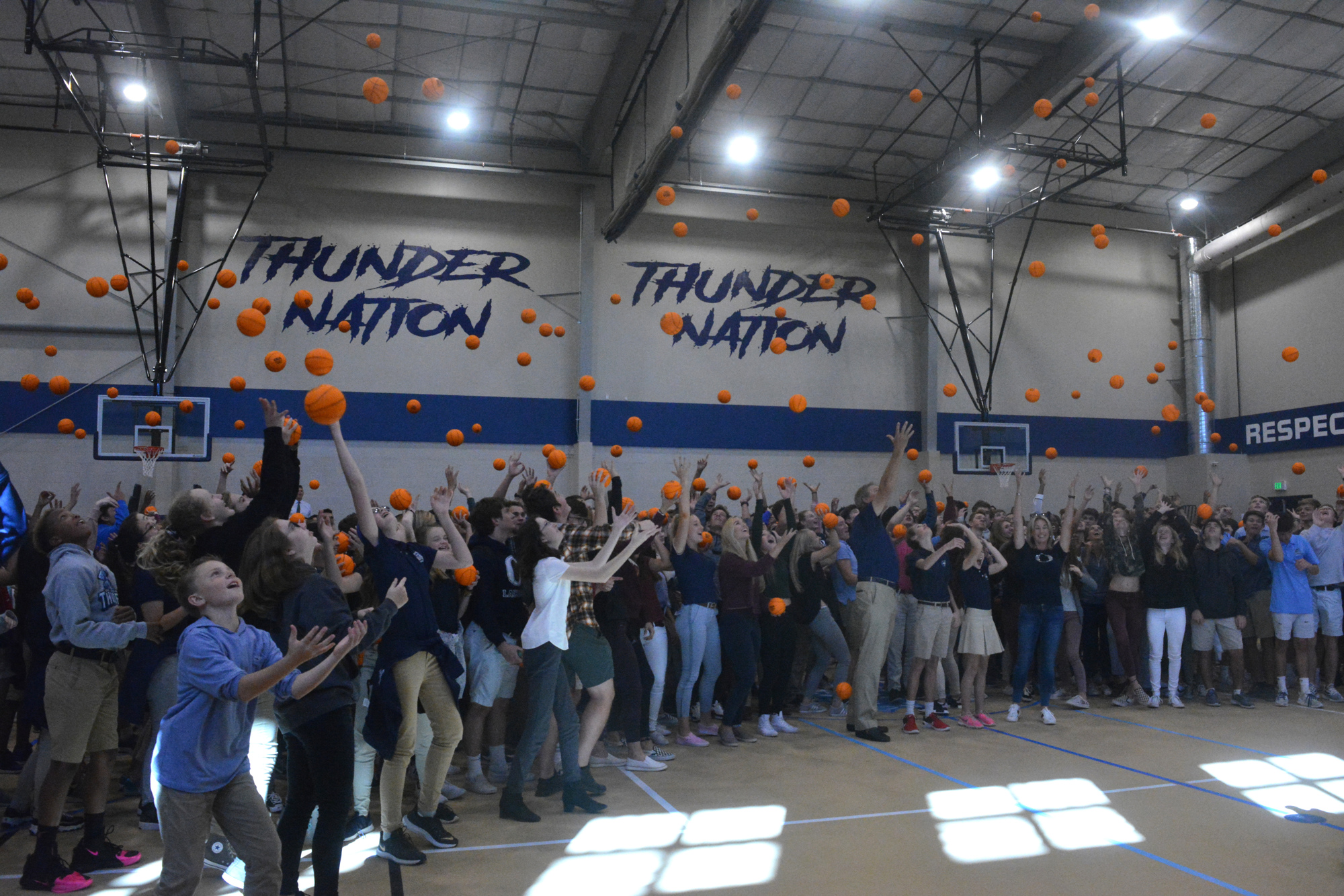 9. The ODA crowd throws commemorative mini-basketballs in the air at the close of the school's ceremony at its new field house.